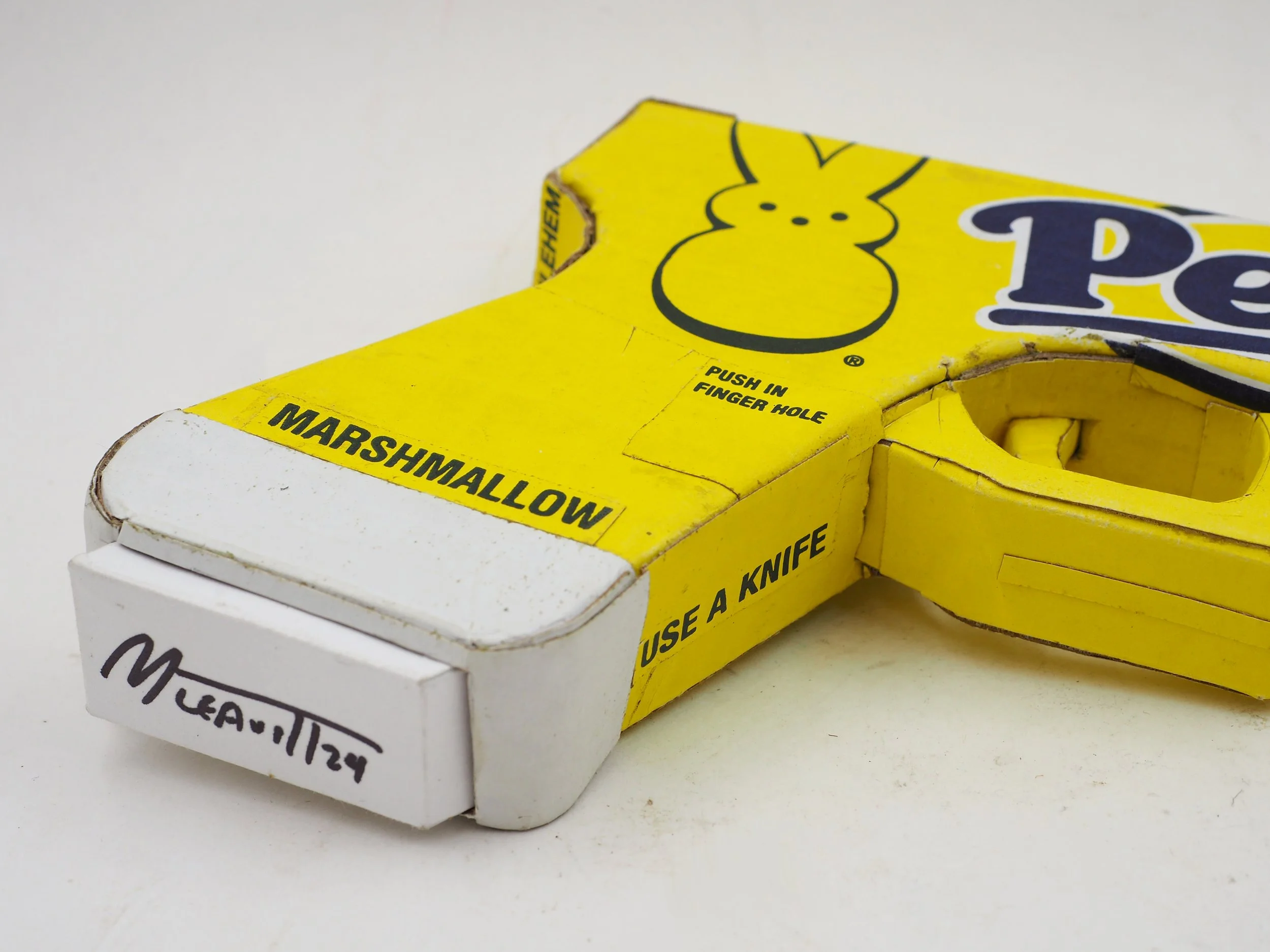 Mass shooting yellow marshmallow Easter candy peeps cardboard recycled material art sculpture political action satire