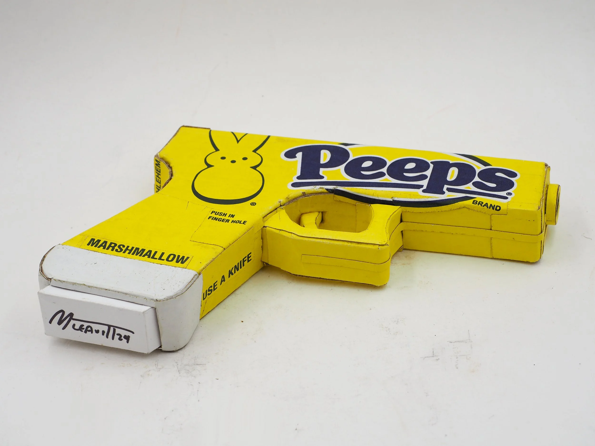 Mass shooting yellow marshmallow Easter candy peeps cardboard recycled material art sculpture political action satire