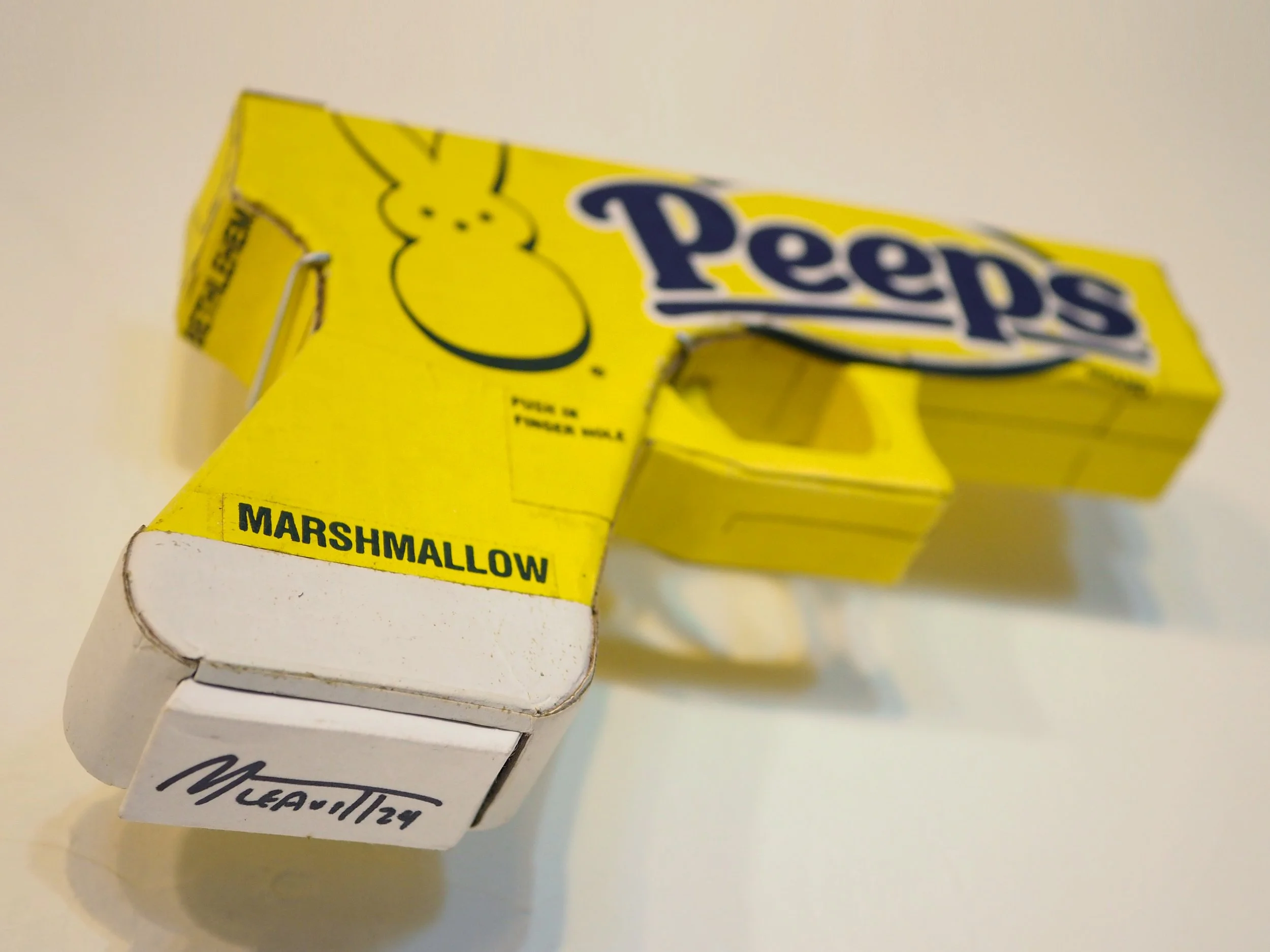 Mass shooting yellow marshmallow Easter candy peeps cardboard recycled material art sculpture political action satire