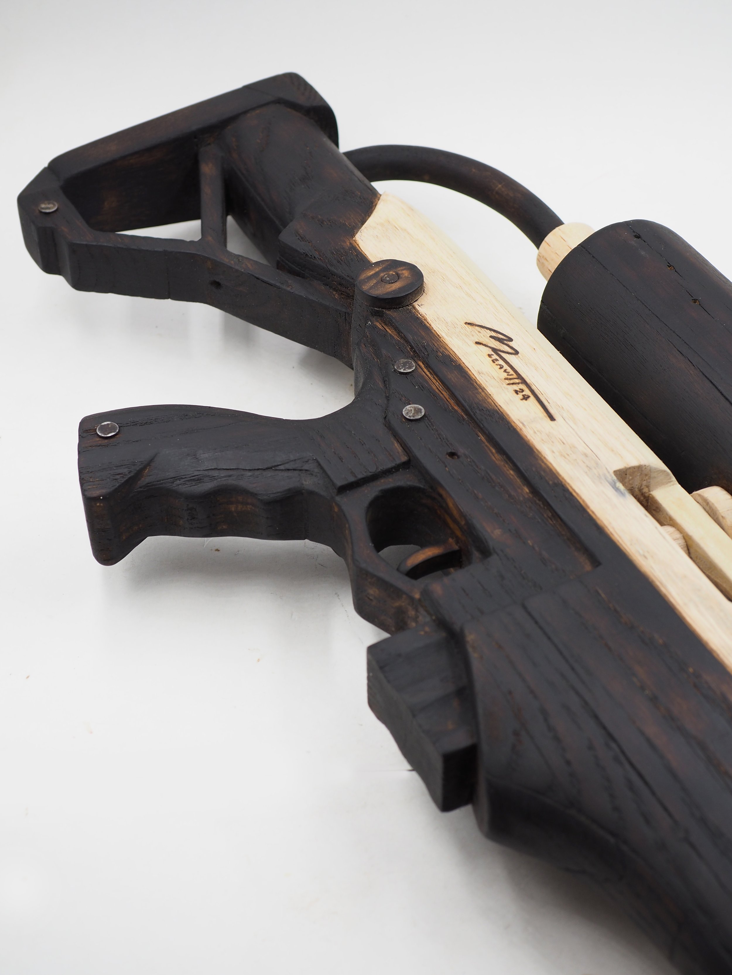 Elon Musk flame thrower Twitter X Tesla corporate culture anti-capitalist woodworking wood sculpture recycled reclaimed pallet wood satire celebrity parody art