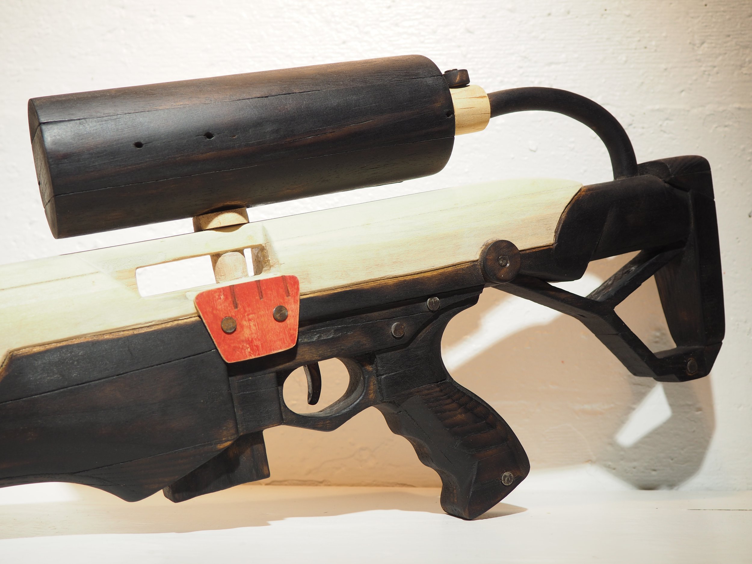 Elon Musk flame thrower Twitter X Tesla corporate culture anti-capitalist woodworking wood sculpture recycled reclaimed pallet wood satire celebrity parody art