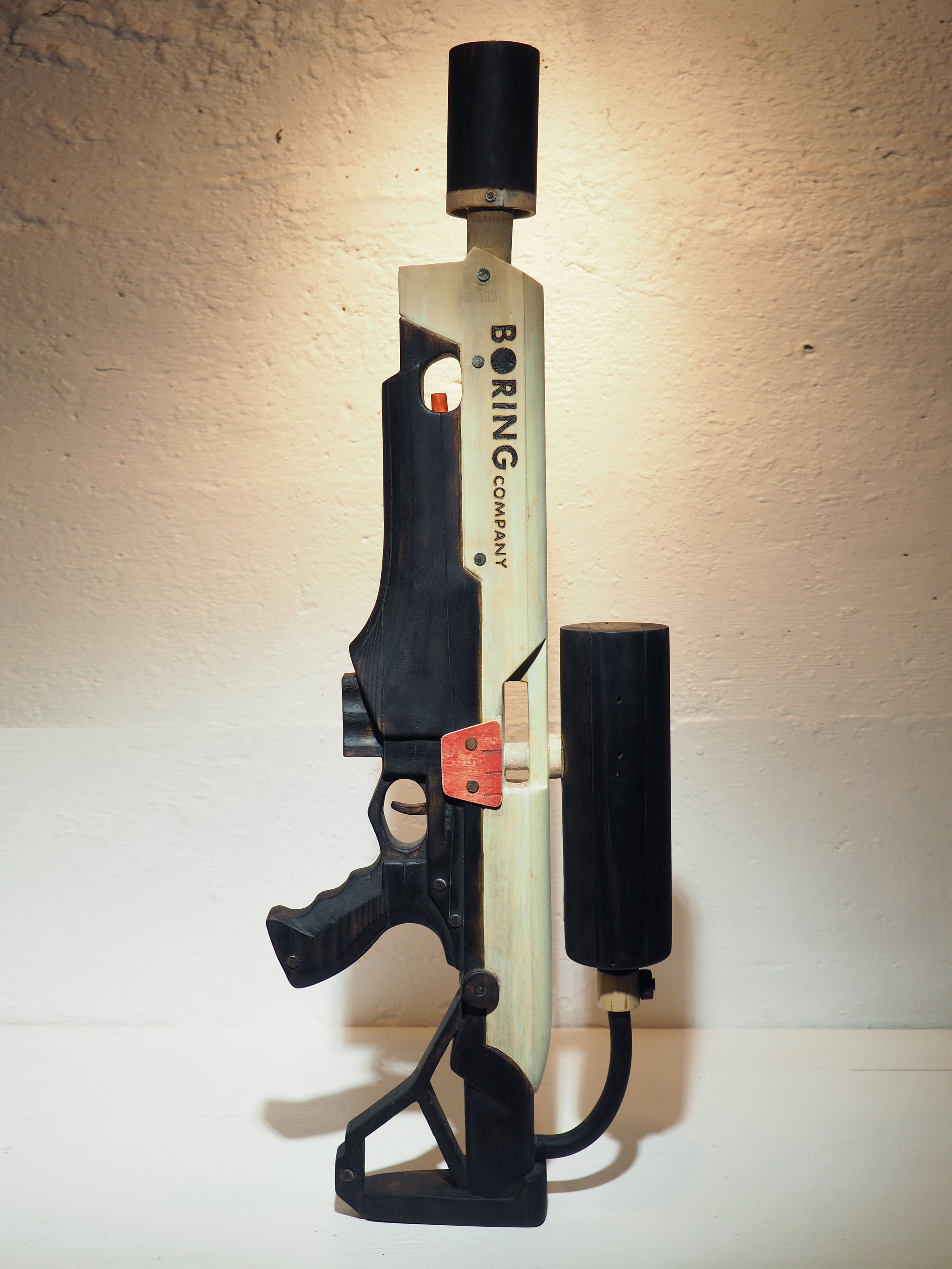 Elon Musk flame thrower Twitter X Tesla corporate culture anti-capitalist woodworking wood sculpture recycled reclaimed pallet wood satire celebrity parody art