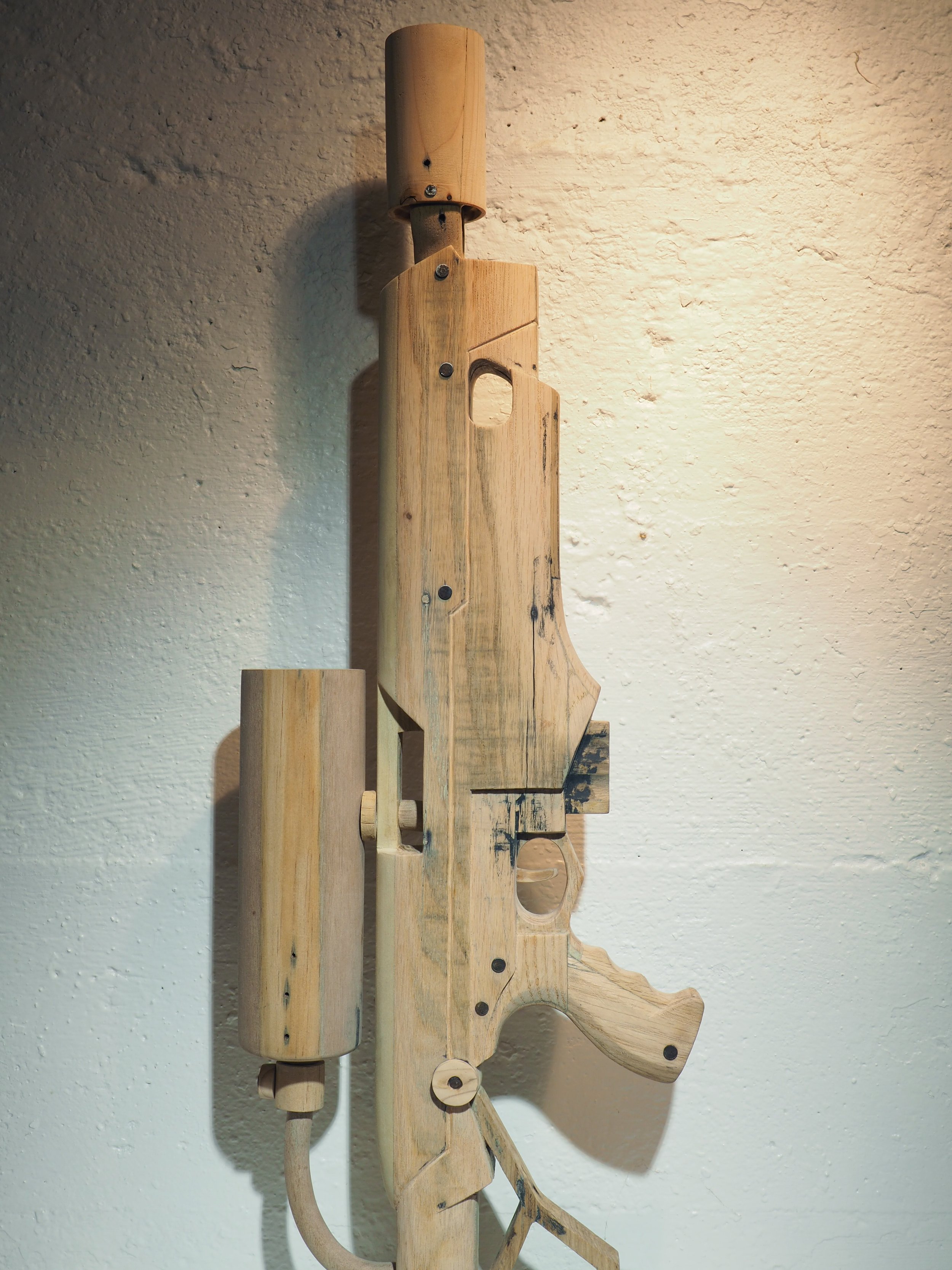 Elon Musk flame thrower Twitter X Tesla corporate culture anti-capitalist woodworking wood sculpture recycled reclaimed pallet wood satire celebrity parody art