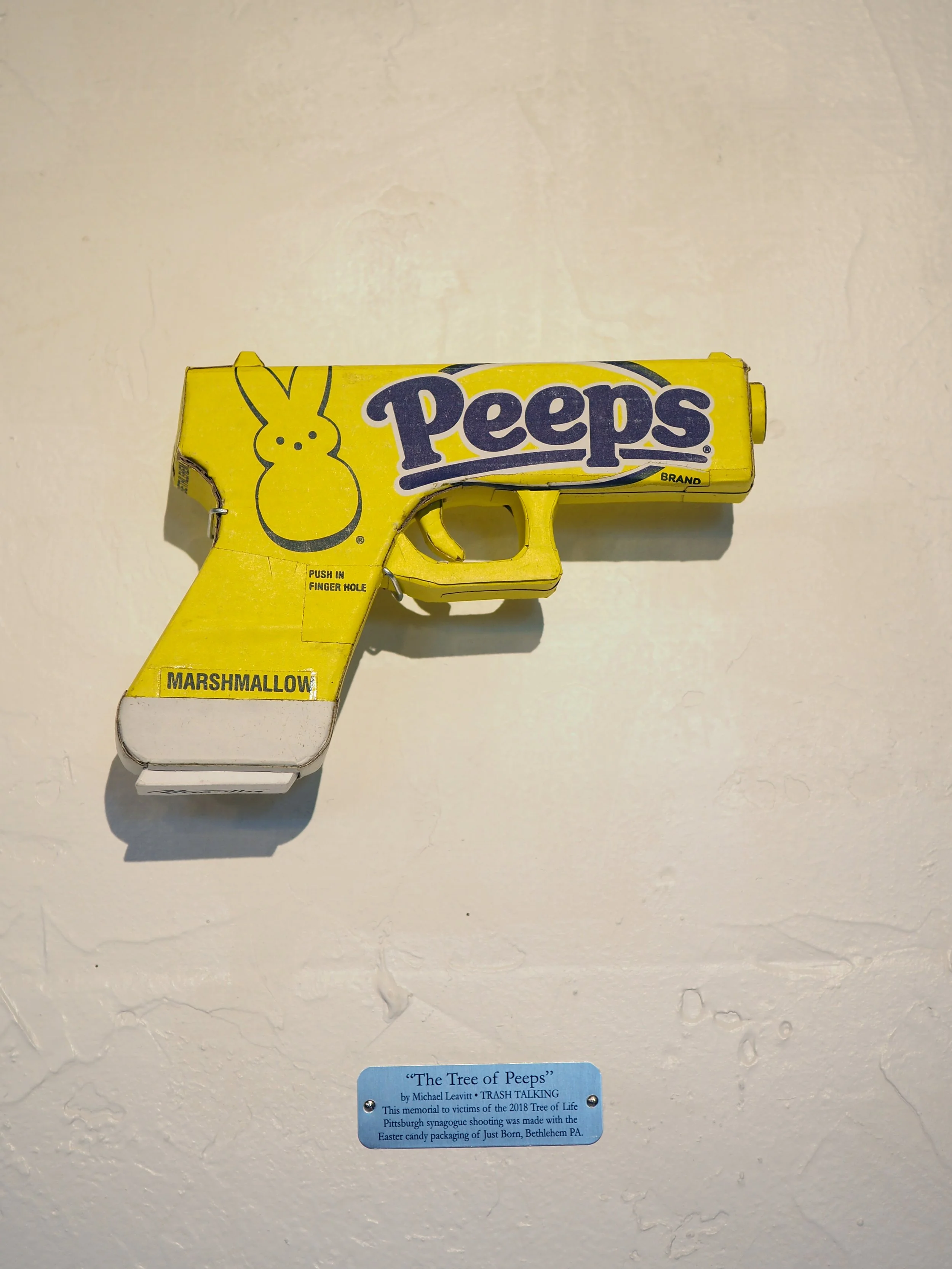 Mass shooting yellow marshmallow Easter candy peeps cardboard recycled material art sculpture political action satire