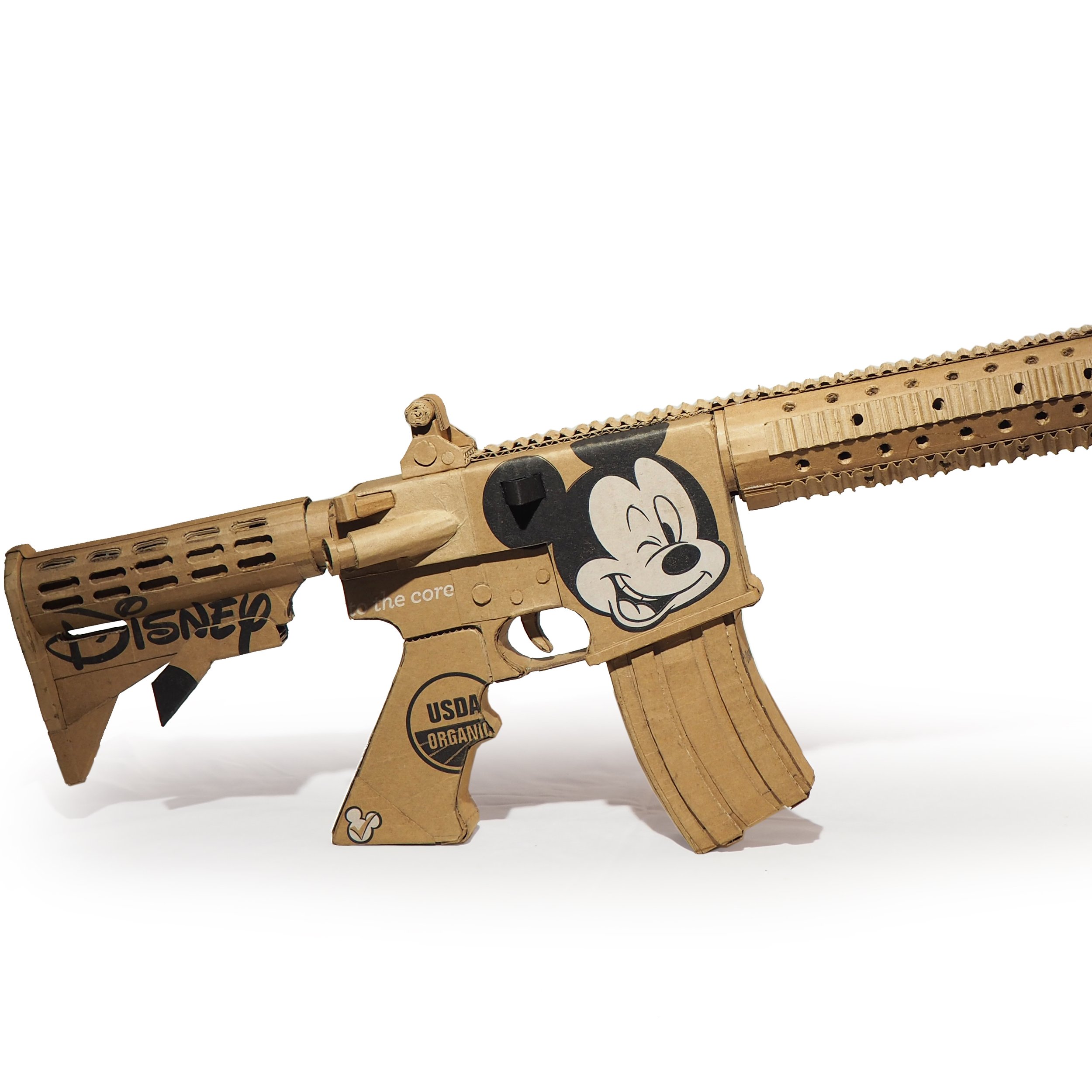 Disney Mickey Mouse anti-capitalist satire Florida mass shooting cardboard recycled material art sculpture political action parody