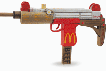 Mass shooting cardboard Uzi recycled material art sculpture political action McDonalds corporate culture parody