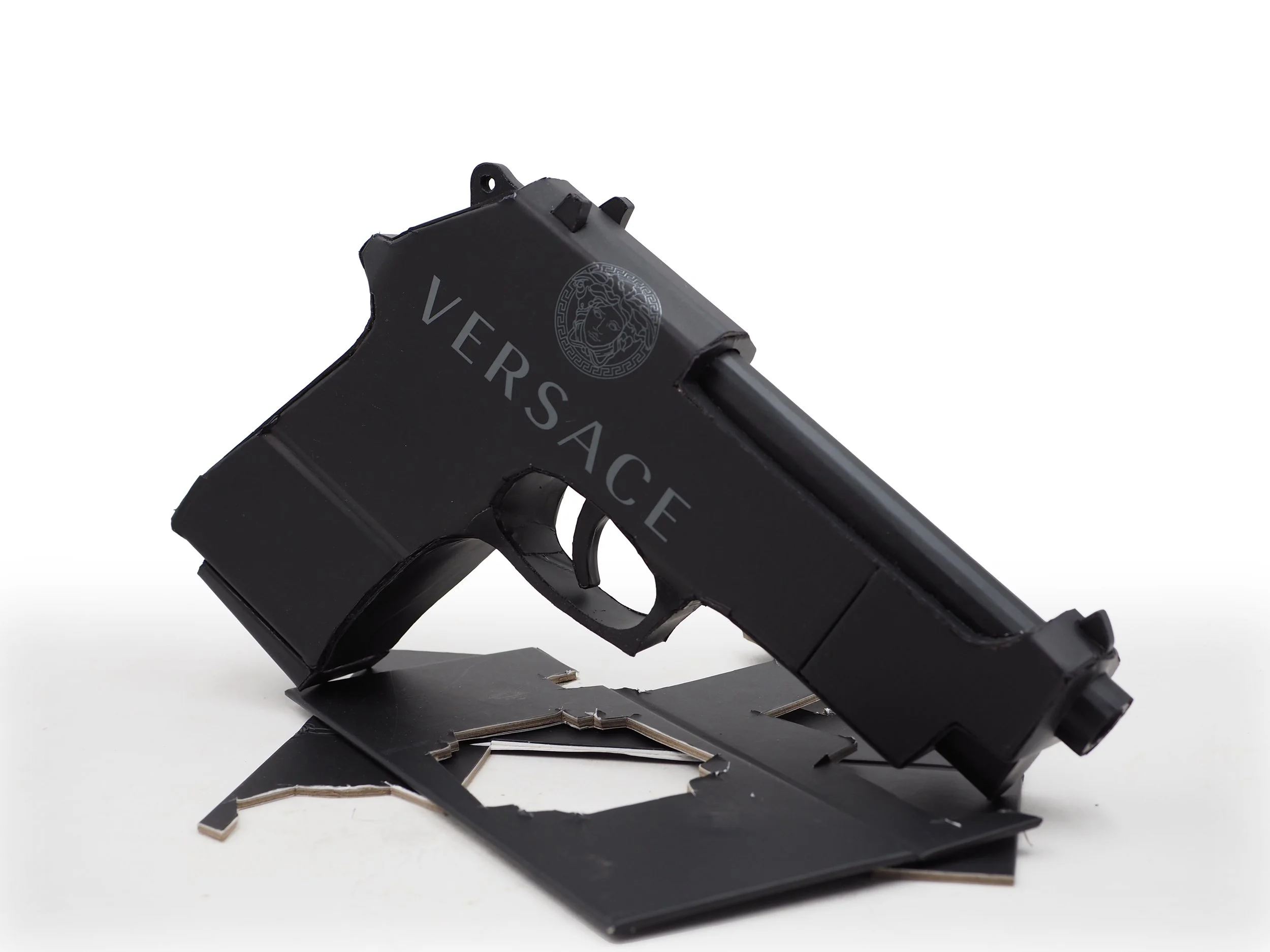 Versace Beretta pistol Italy recycled cardboard waste packaging high fashion luxury brand comedy satire parody lampoon art sculpture