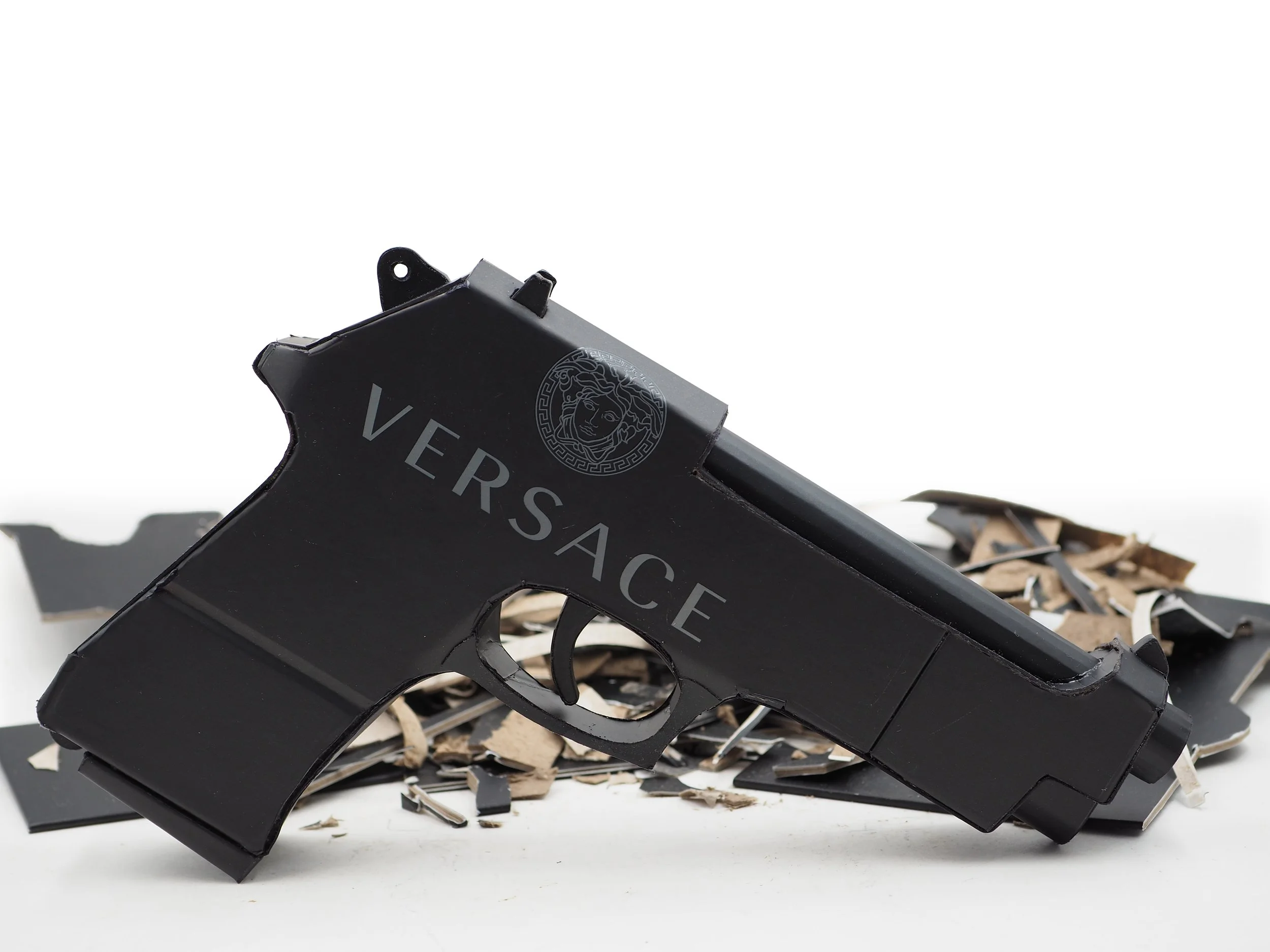 Versace Beretta pistol Italy recycled cardboard waste packaging high fashion luxury brand comedy satire parody lampoon art sculpture