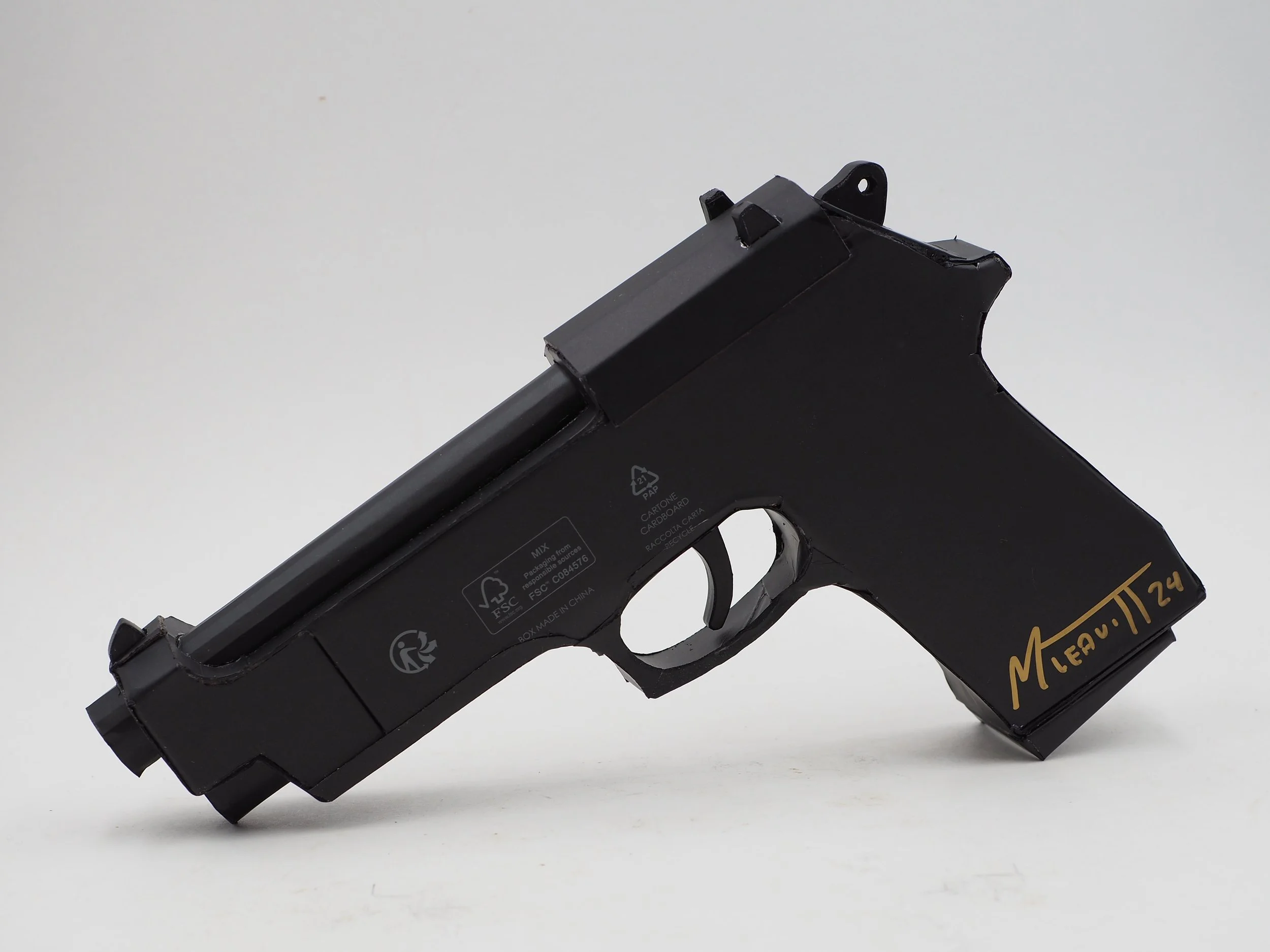 Versace Beretta pistol Italy recycled cardboard waste packaging high fashion luxury brand comedy satire parody lampoon art sculpture