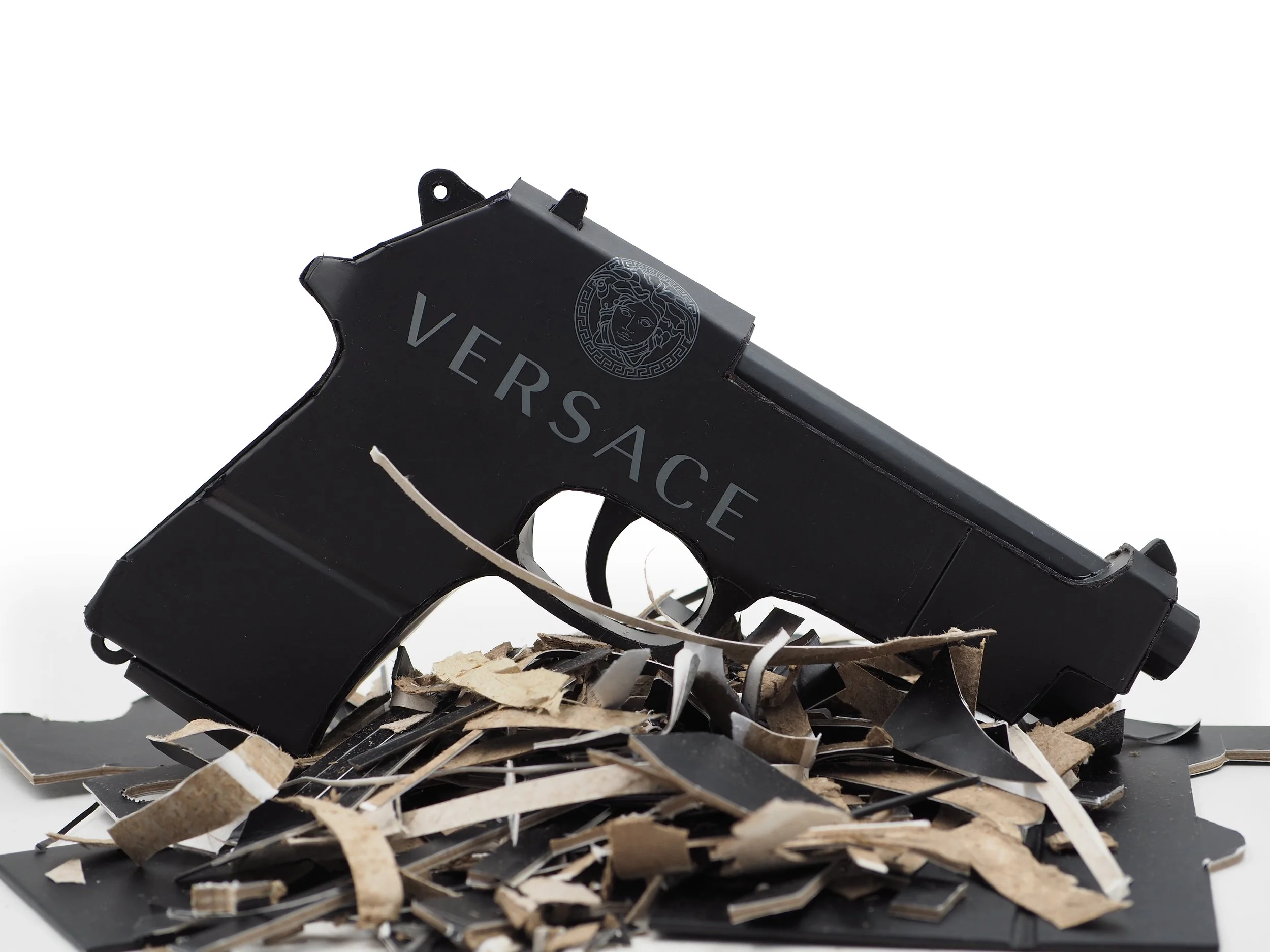 Versace Beretta pistol Italy recycled cardboard waste packaging high fashion luxury brand comedy satire parody lampoon art sculpture