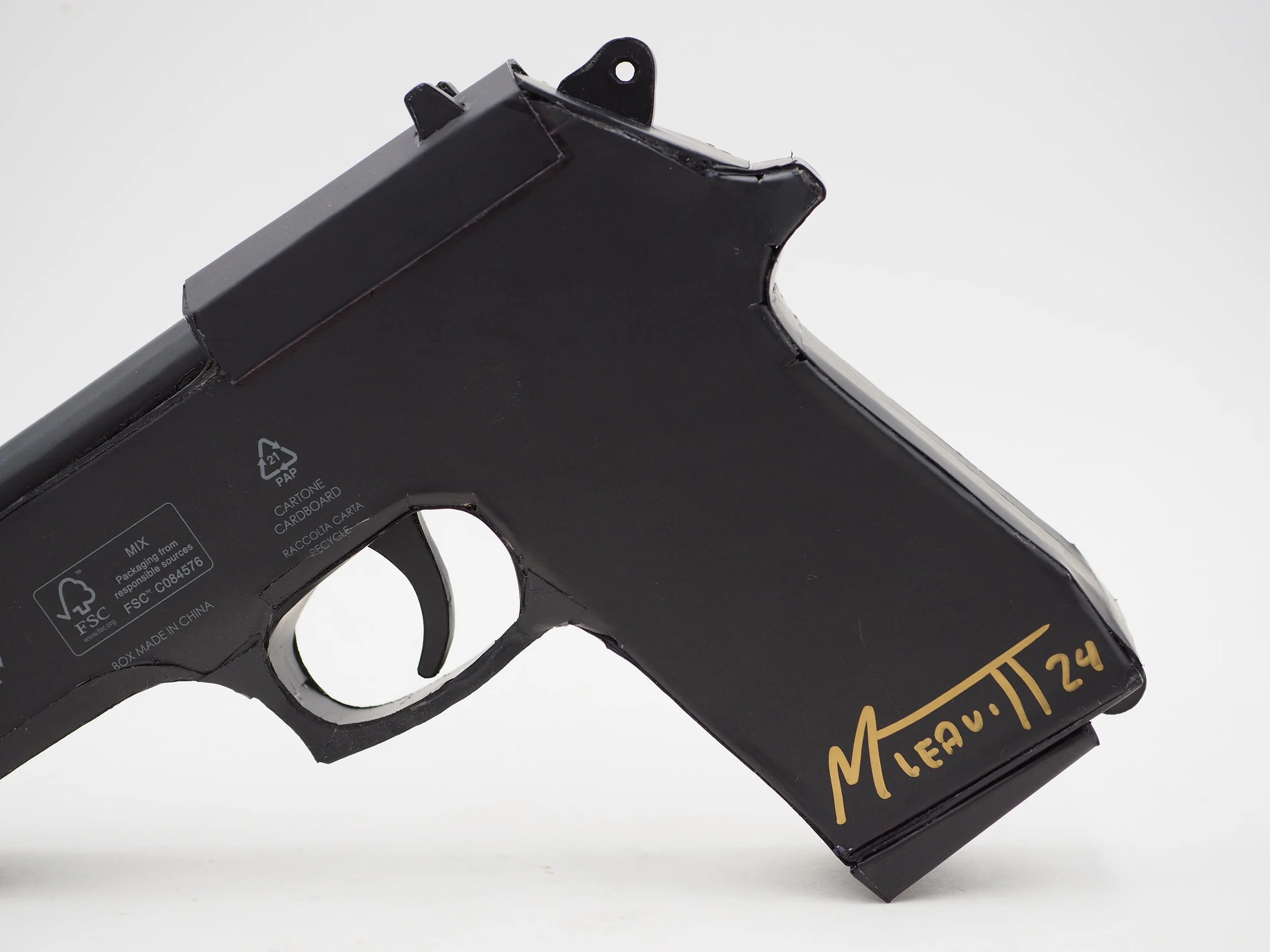 Versace Beretta pistol Italy recycled cardboard waste packaging high fashion luxury brand comedy satire parody lampoon art sculpture