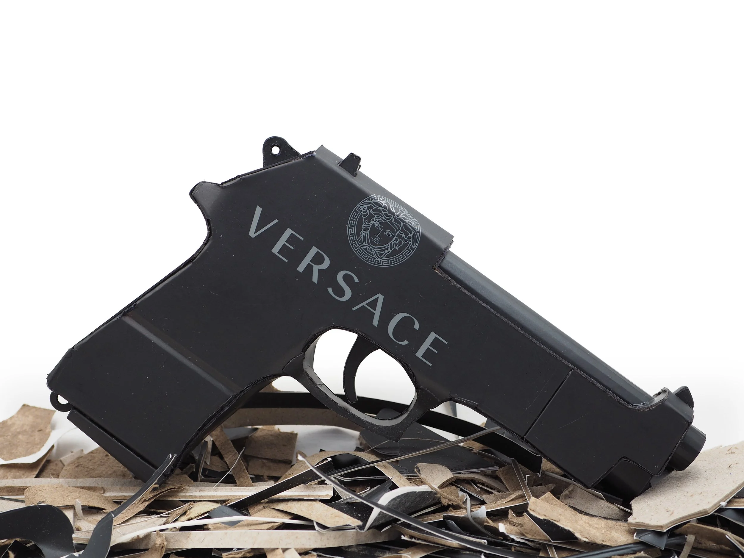 Versace Beretta pistol Italy recycled cardboard waste packaging high fashion luxury brand comedy satire parody lampoon art sculpture