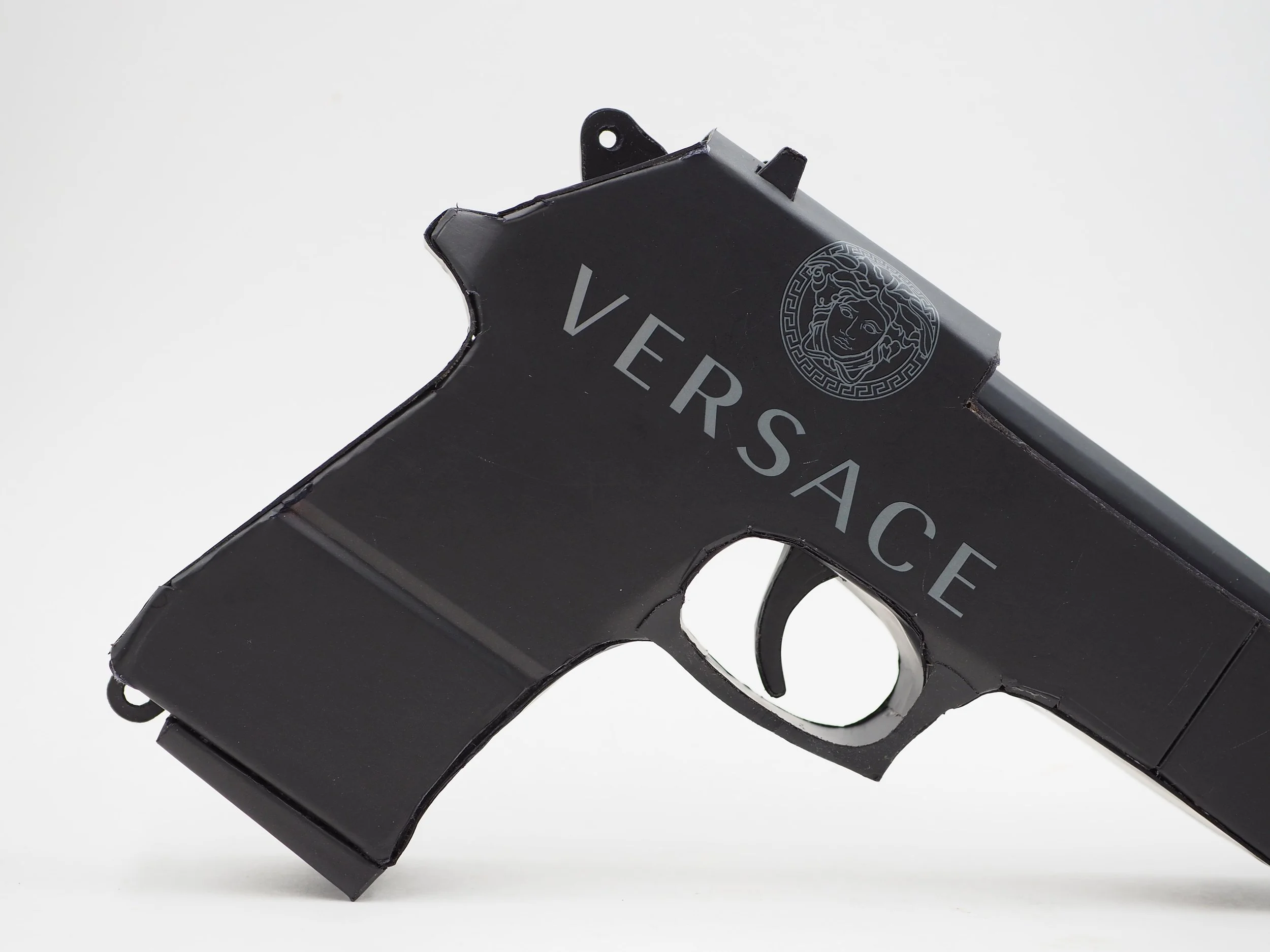 Versace Beretta pistol Italy recycled cardboard waste packaging high fashion luxury brand comedy satire parody lampoon art sculpture