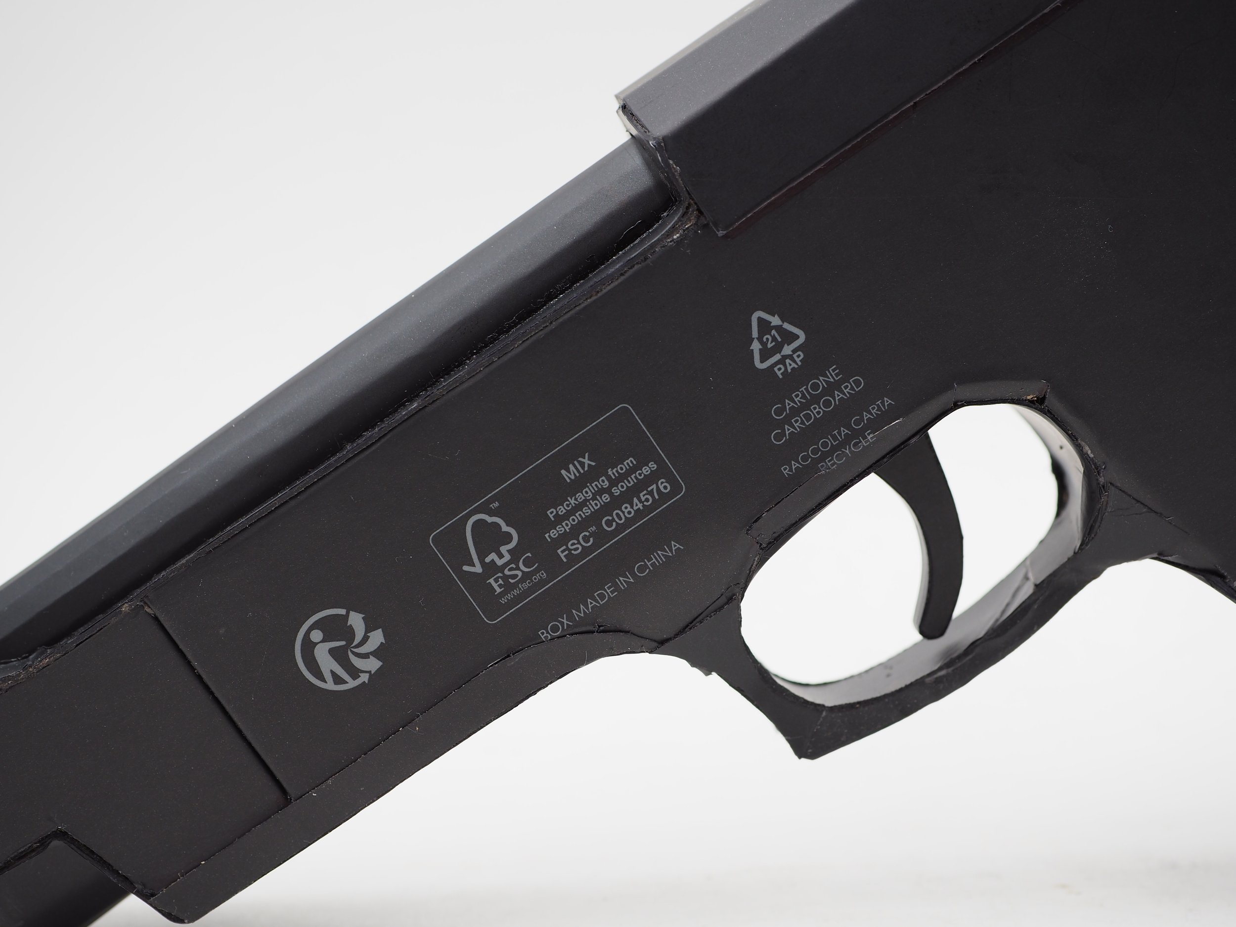 Versace Beretta pistol Italy recycled cardboard waste packaging high fashion luxury brand comedy satire parody lampoon art sculpture