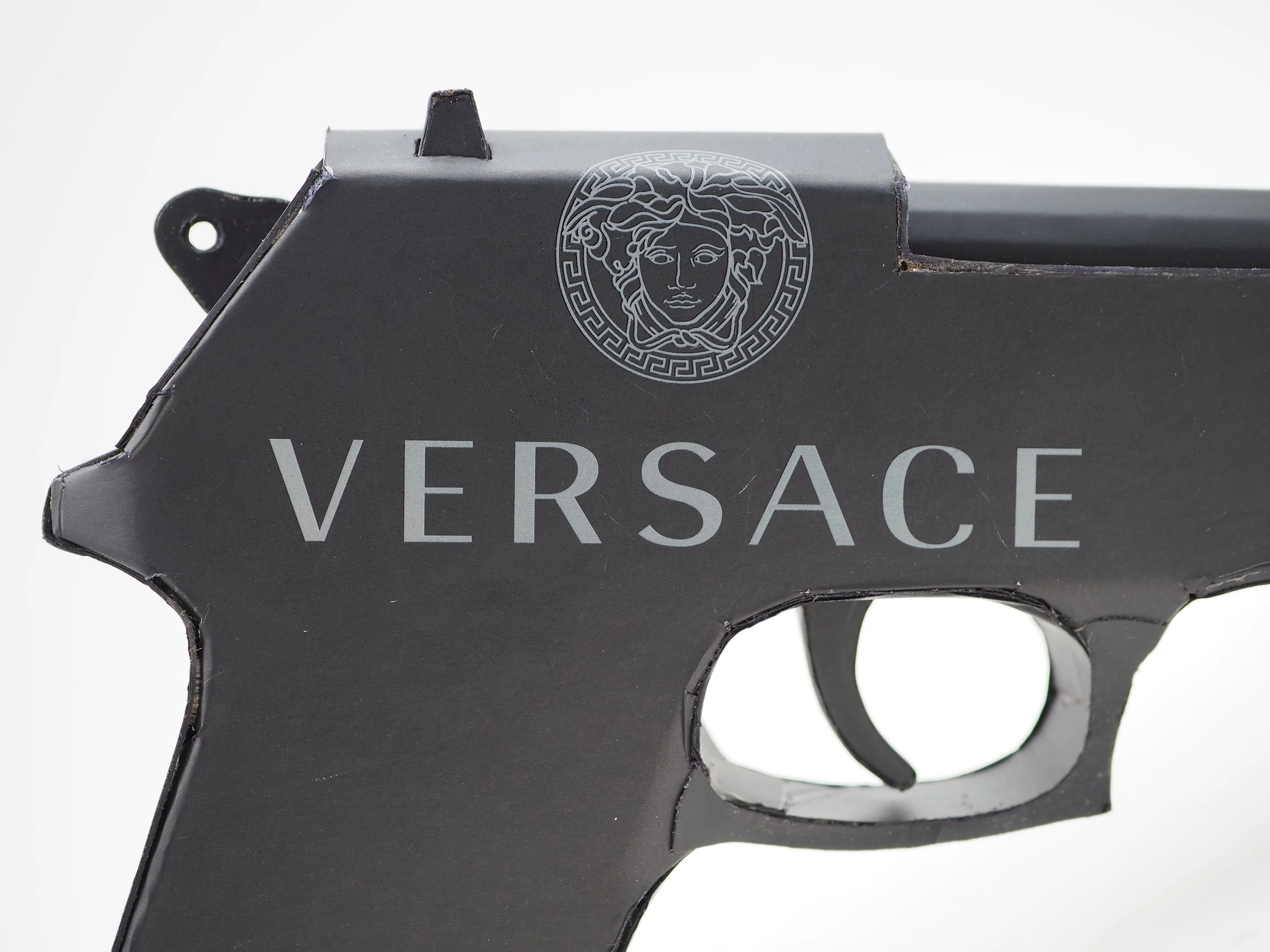 Versace Beretta pistol Italy recycled cardboard waste packaging high fashion luxury brand comedy satire parody lampoon art sculpture