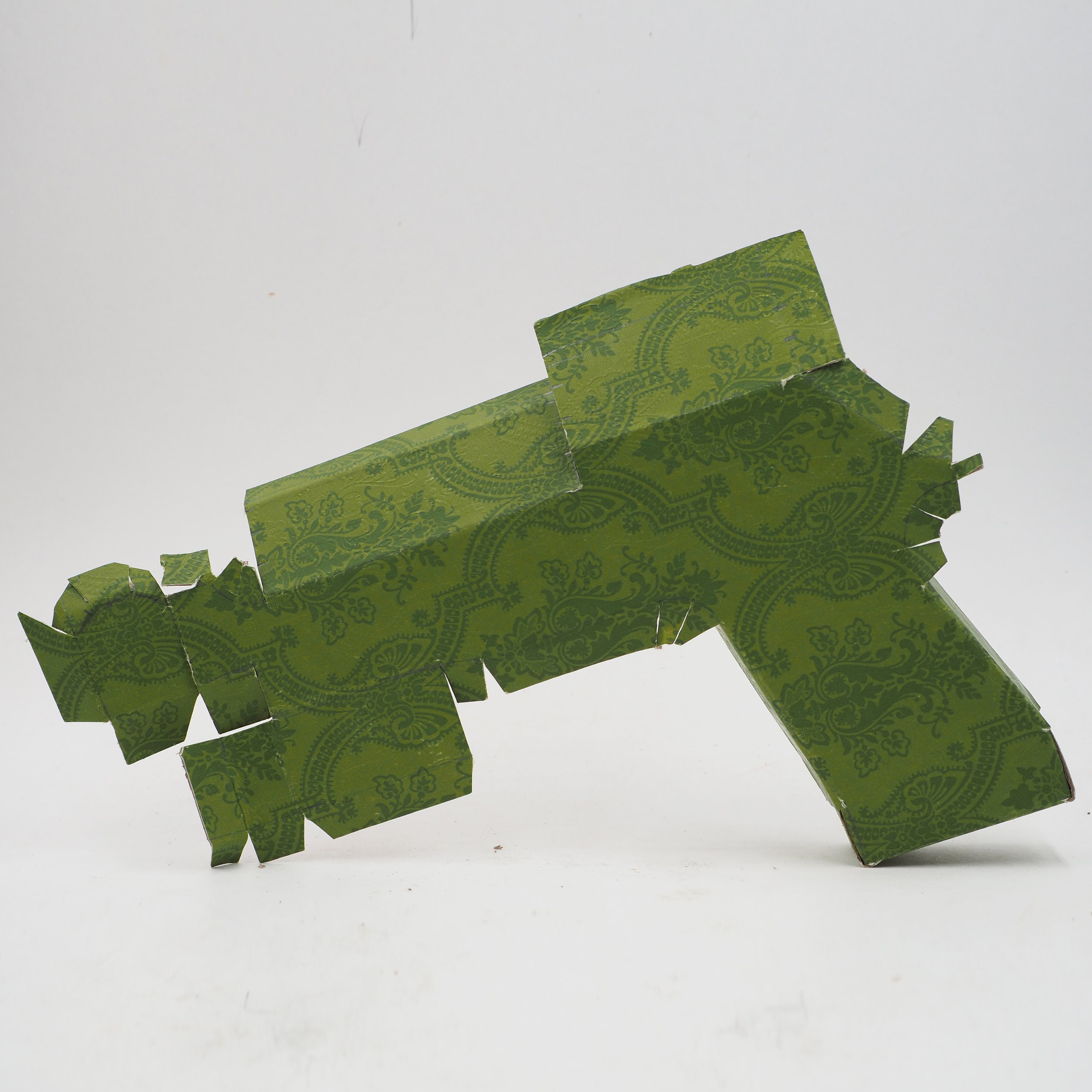 Gucci Beretta pistol Italy recycled cardboard waste packaging high fashion luxury brand comedy satire parody lampoon art sculpture