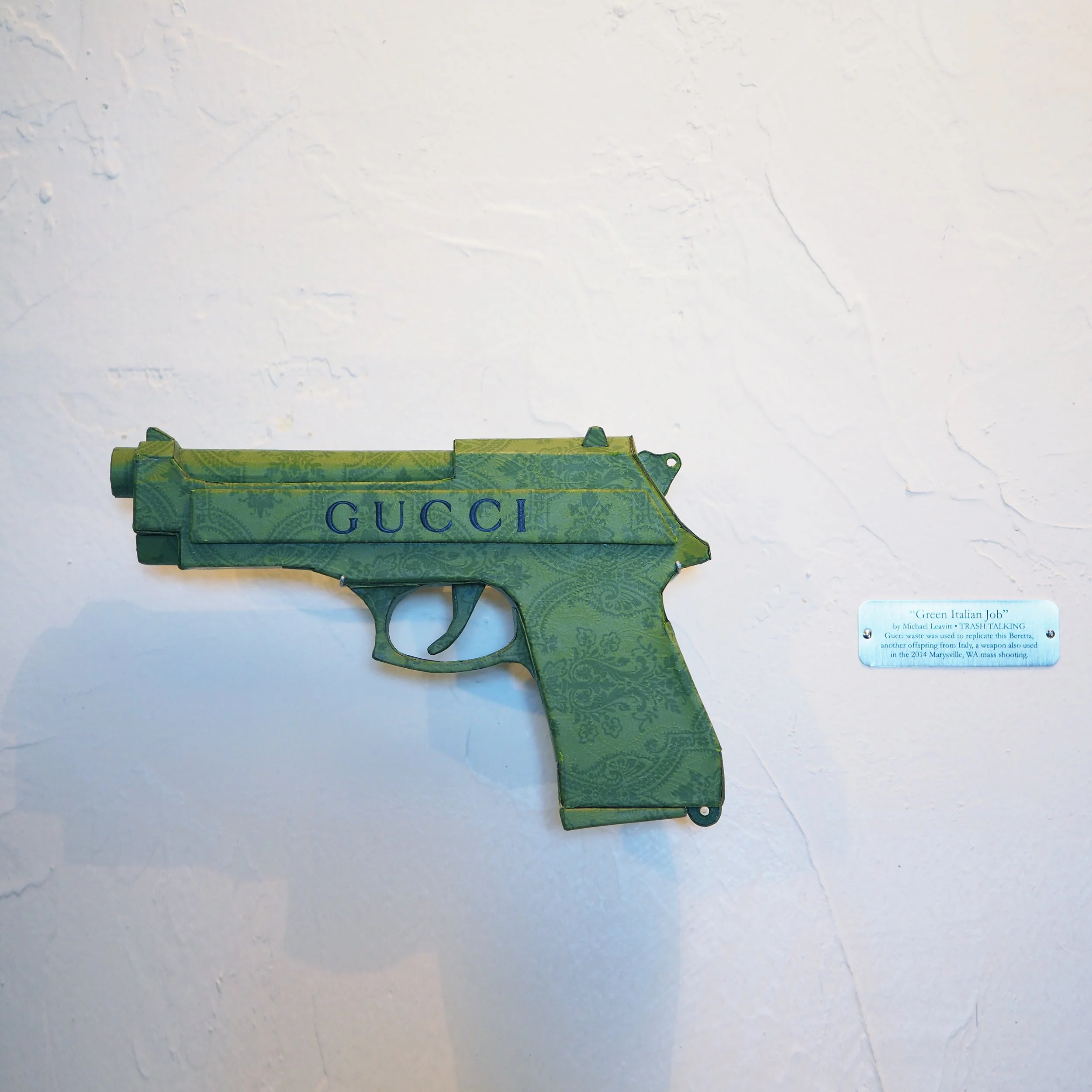 Gucci Beretta pistol Italy recycled cardboard waste packaging high fashion luxury brand comedy satire parody lampoon art sculpture