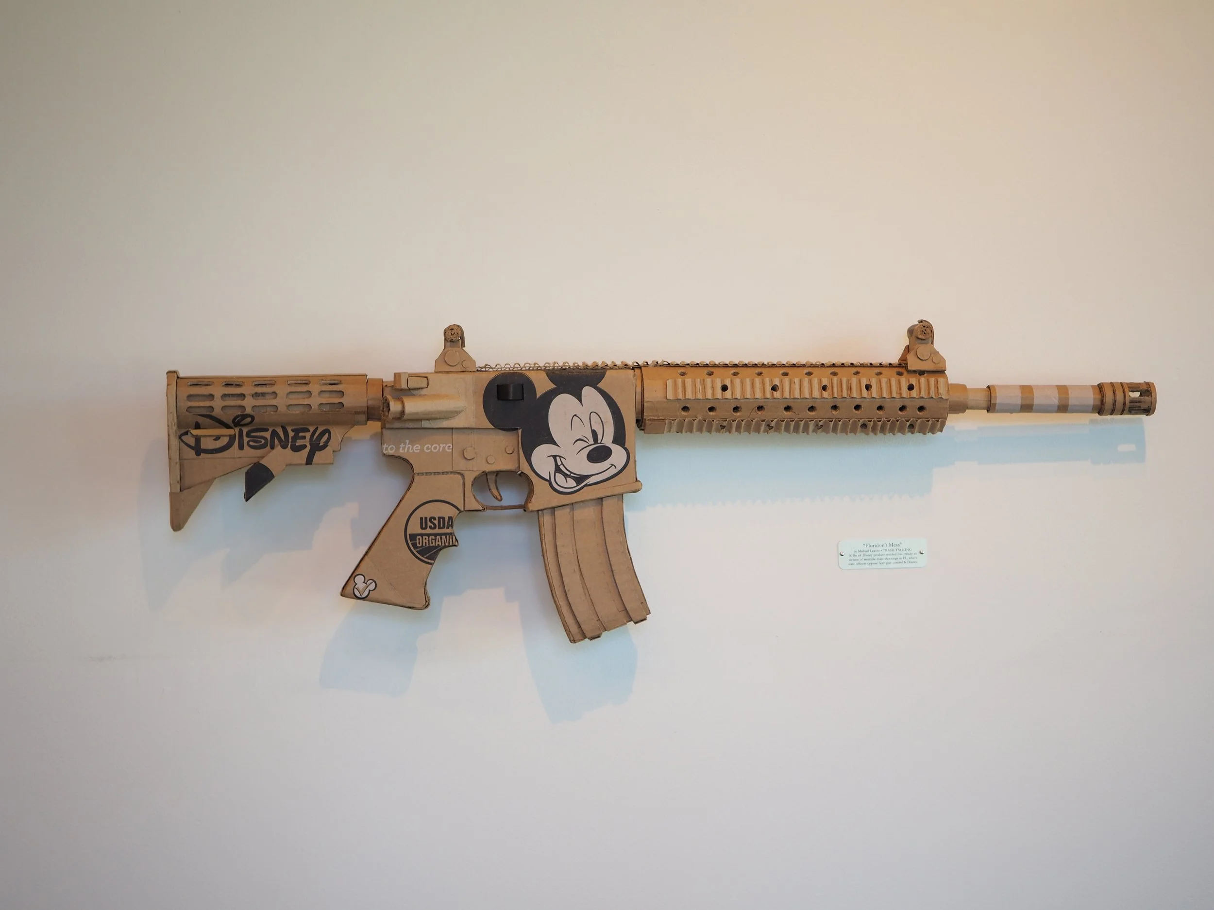 Disney Mickey Mouse satire Florida mass shooting cardboard recycled material art sculpture political action parody