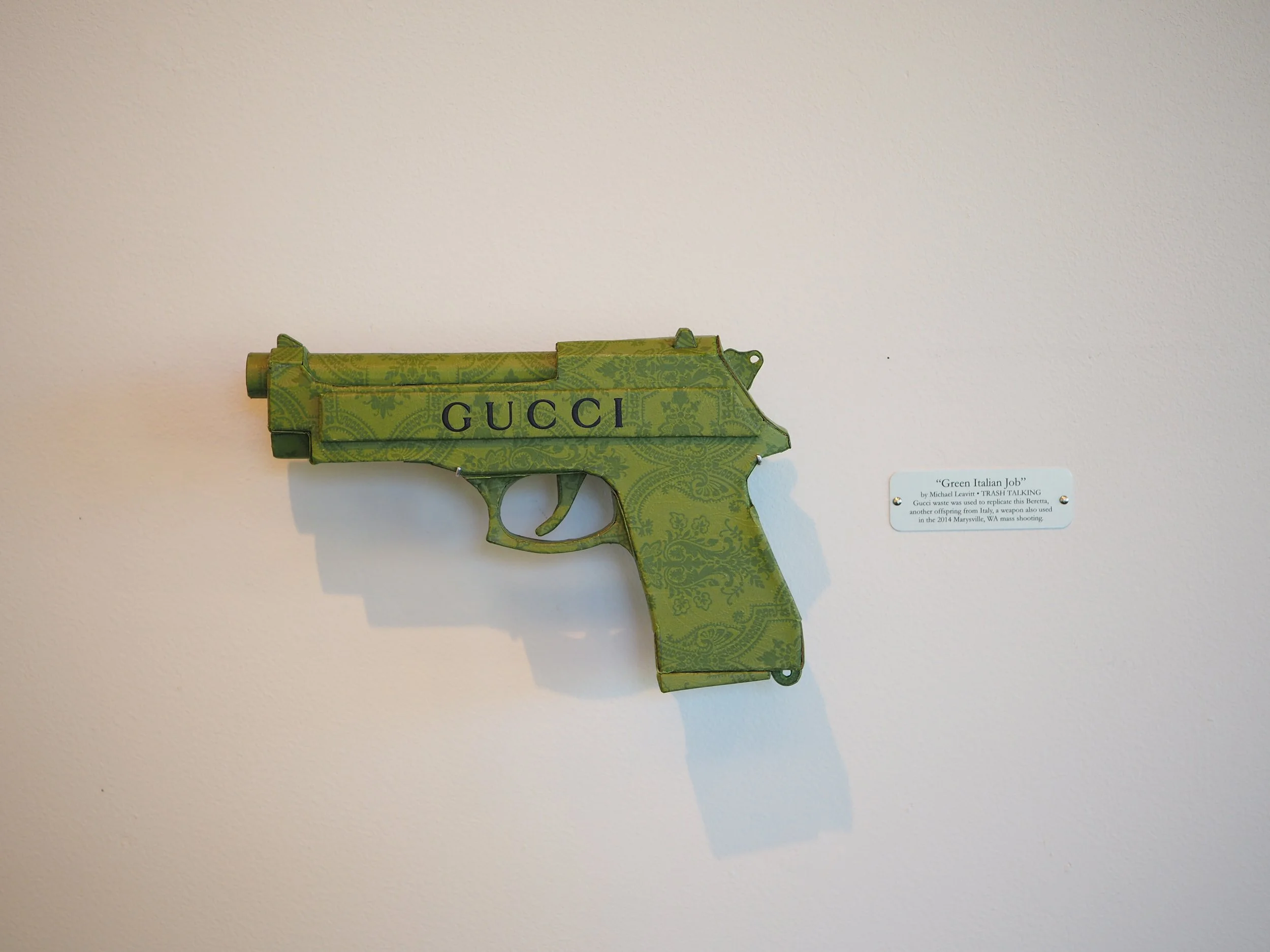 Gucci Beretta pistol Italy recycled cardboard waste packaging high fashion luxury brand comedy satire parody lampoon art sculpture