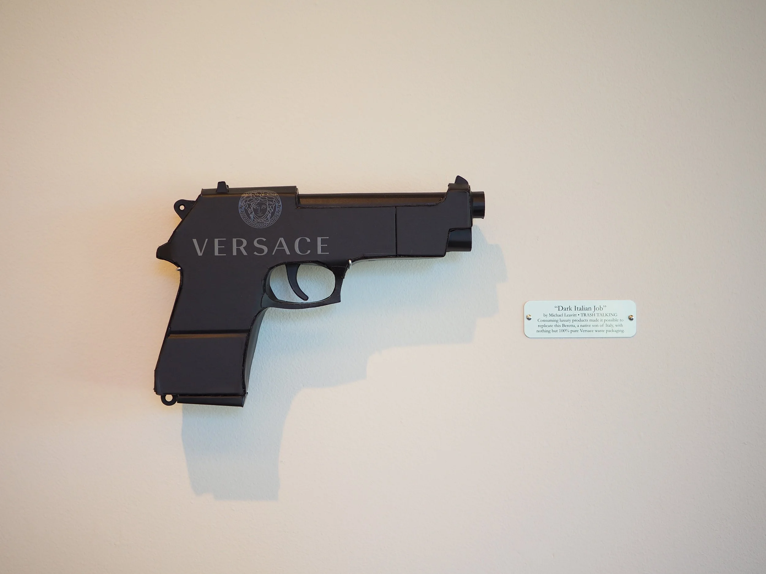 Versace Beretta black pistol Italy recycled cardboard waste packaging high fashion luxury brand comedy satire parody lampoon art sculpture