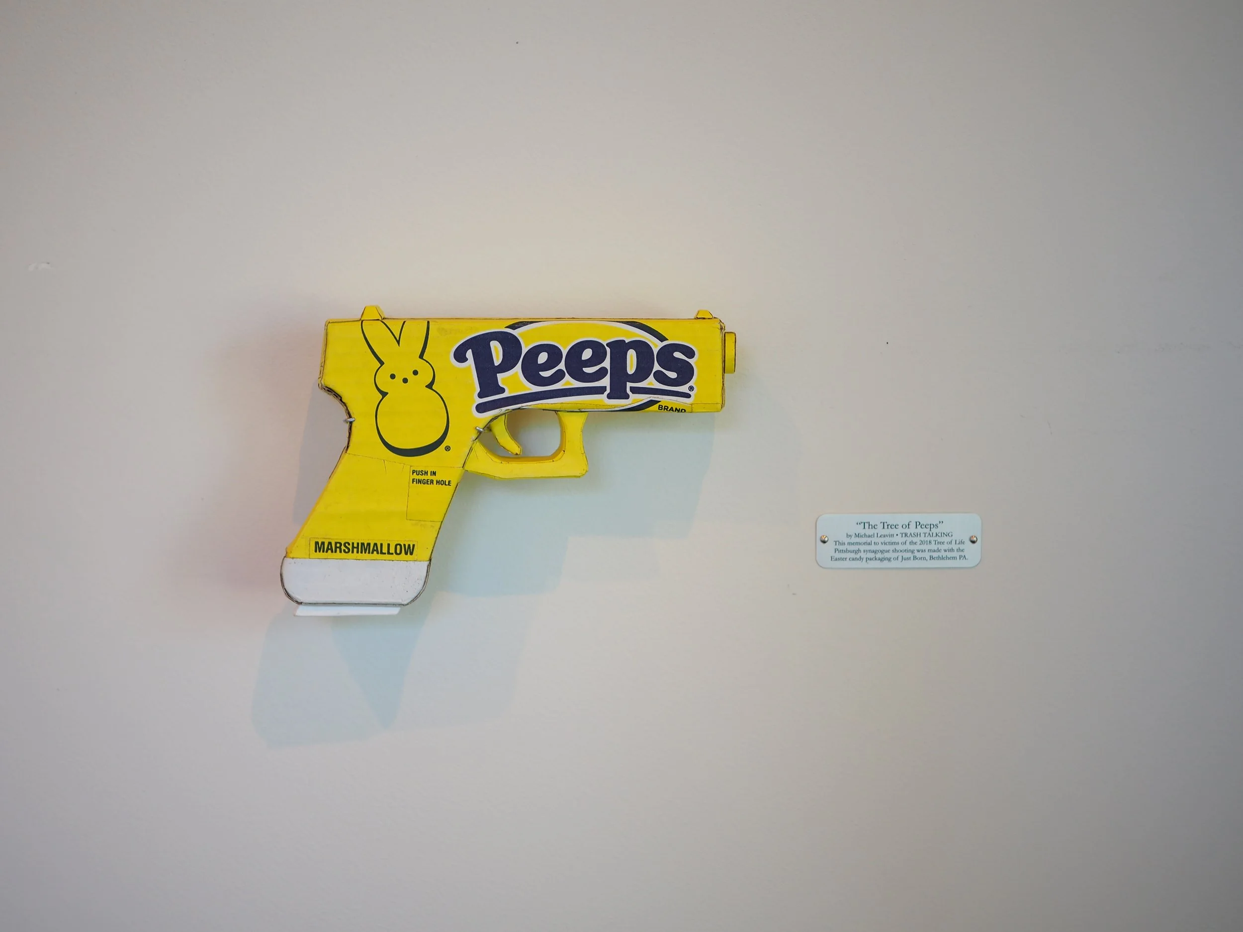 Mass shooting yellow marshmallow Easter candy peeps cardboard recycled material art sculpture political action satire