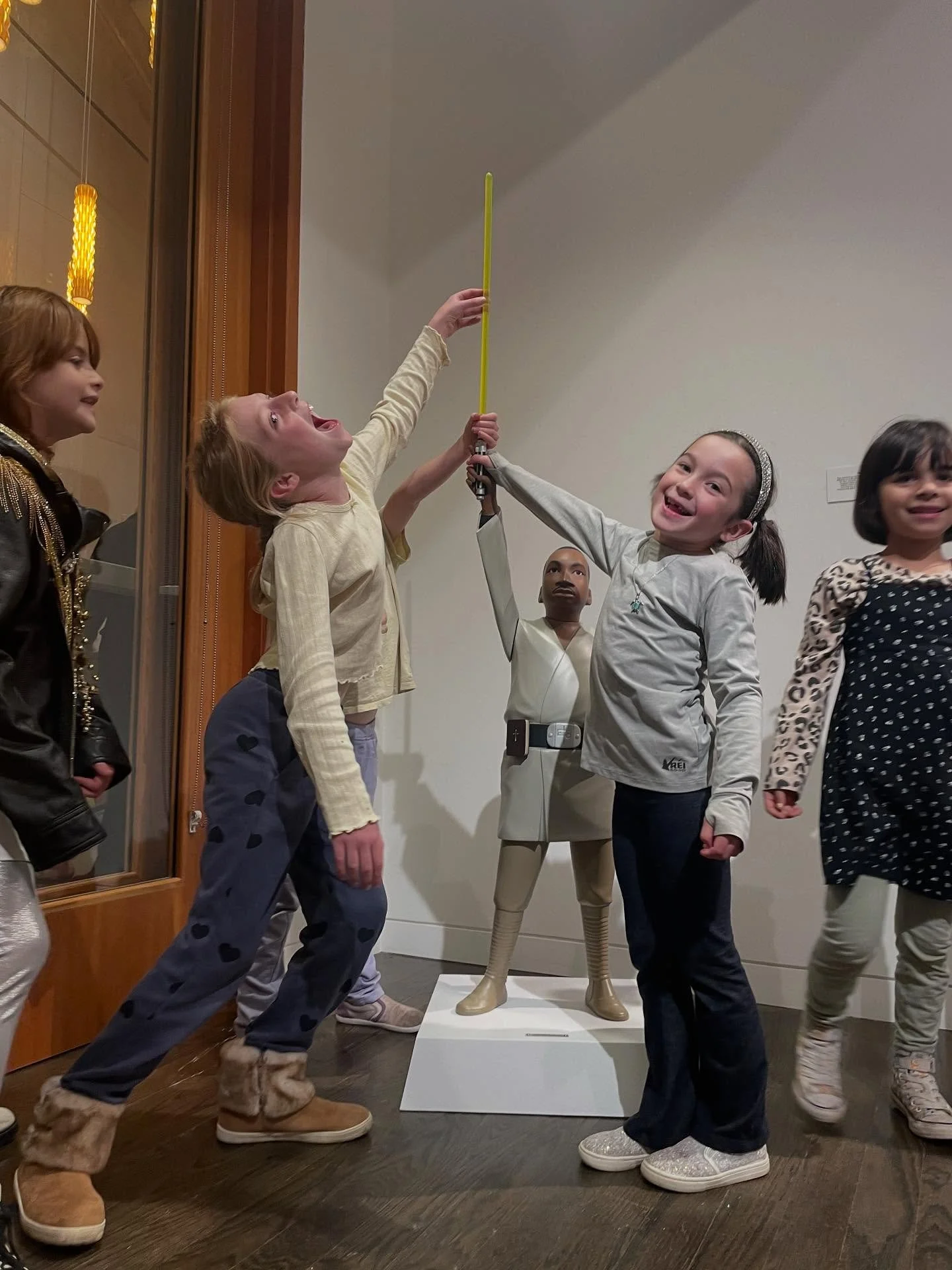 the pure glory that happens when you let human hands touch art. Look how happy the children are! Take down the velvet ropes. Remove the barriers. Go see it in person. The &ldquo;Kingwalker&rdquo; piece buried in this pack of sweet, small souls is one