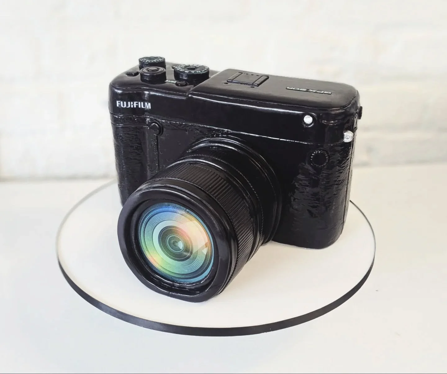 Larger-than-life replica of a groom's Fujifilm camera!
⠀

⠀

⠀

⠀

⠀

⠀

⠀

⠀

⠀

⠀

#fujifilmgfx50r #fujifilmgfxseries #fujifilmcake #cameracake #cameracakes #cameracaketopper #photographercake #photographycake #photographycakes #groomscakes #grooms