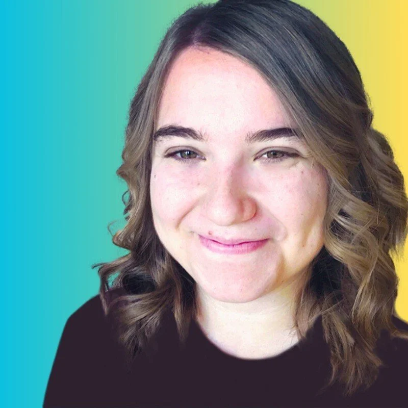 Close-up of a young woman with brown, shoulder-length, wavy hair smiling against a colorful background with gradient teal and yellow.