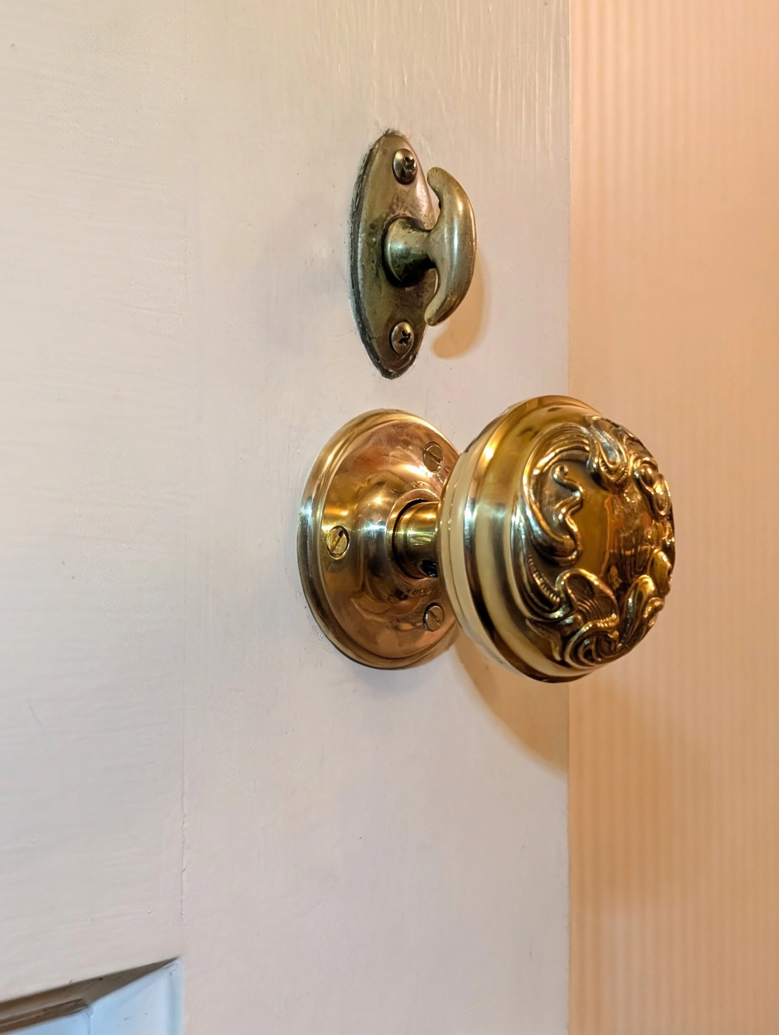 Forged-brass Art Nouveau doorknob installation in Newton, MA