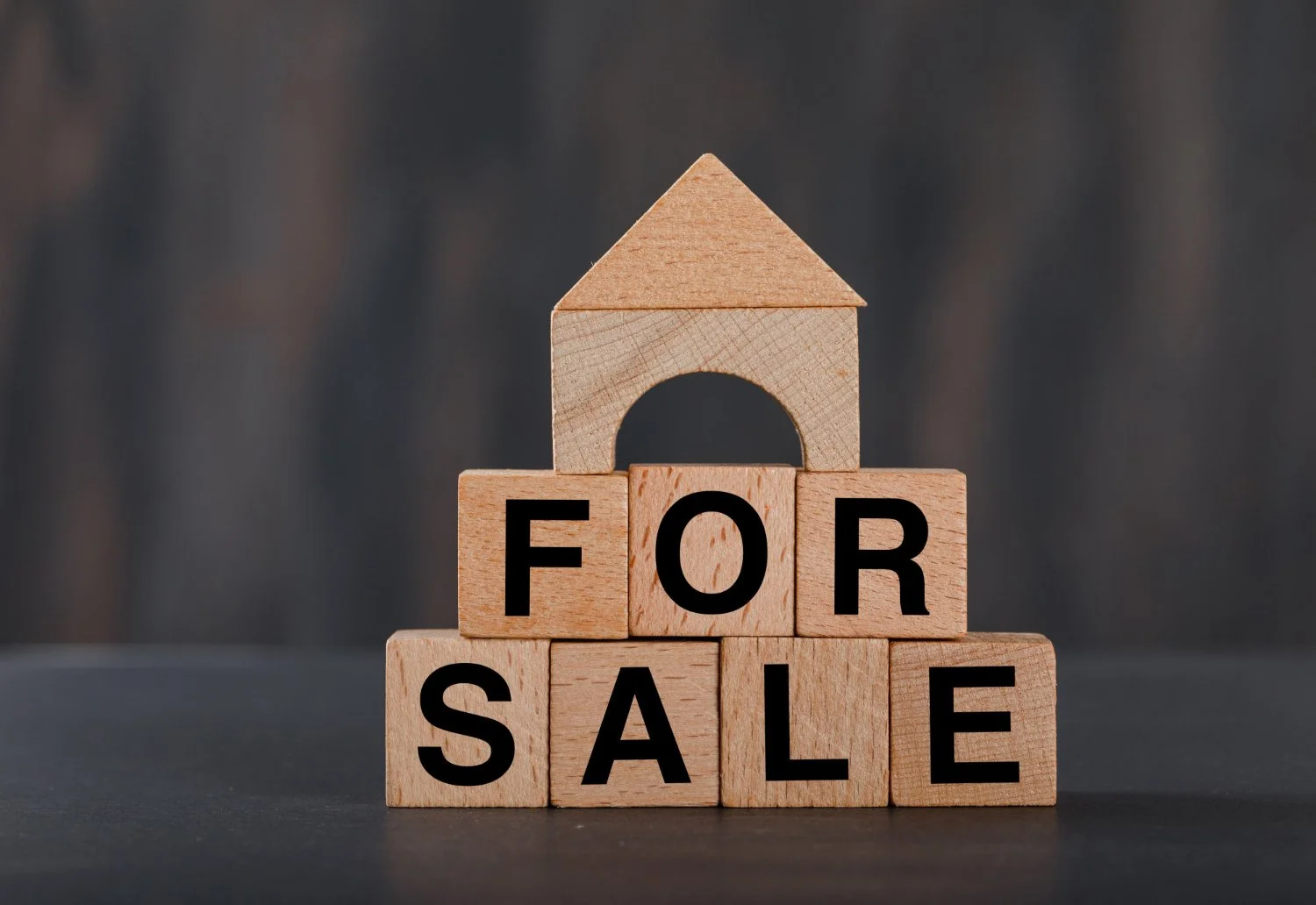 Wooden house blocks forming 'for sale'