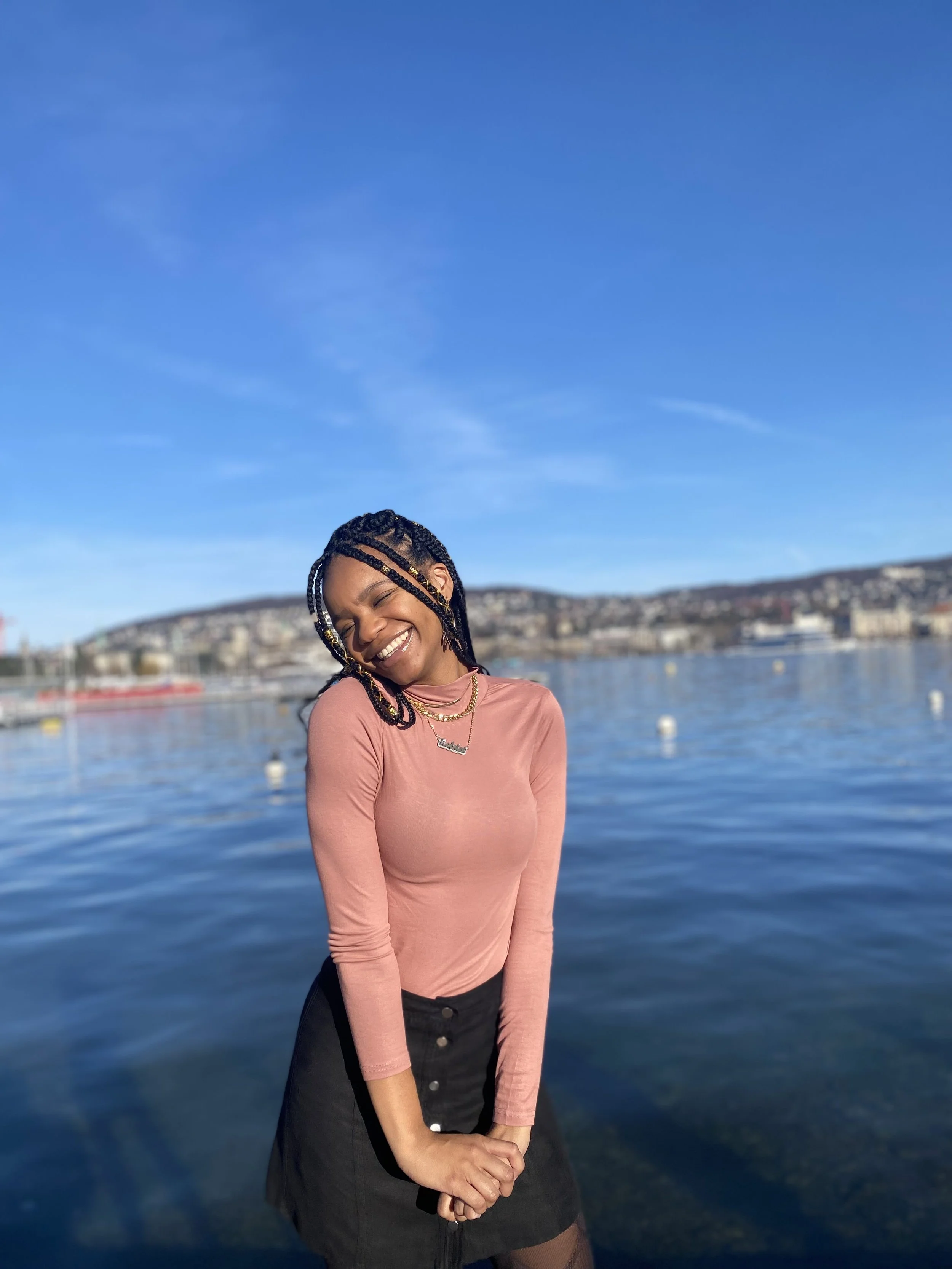 A woman standing in front of Lake Zurich