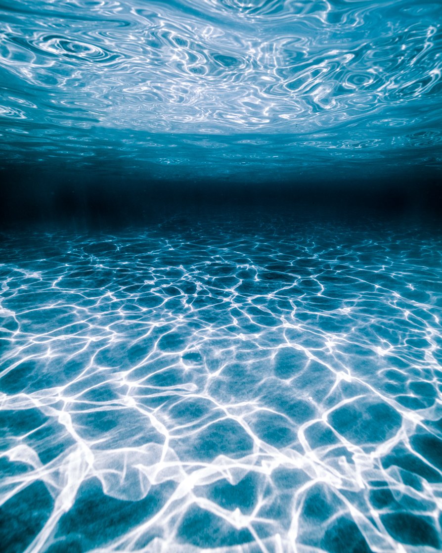 Fine art photograph showing light and texture cast from the ocean surface to the sea floor.