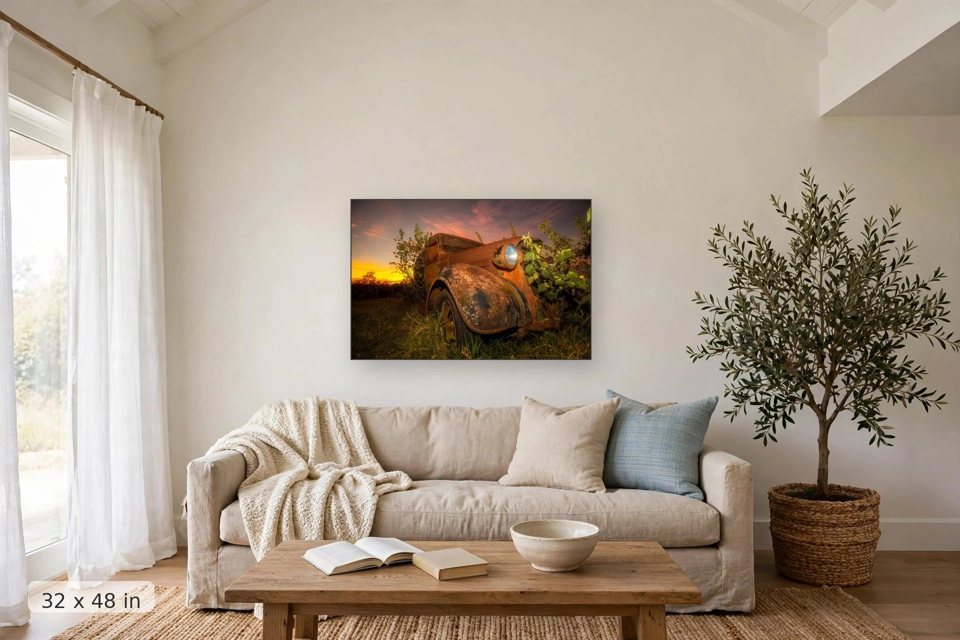 plants overtaking rusty old truck with pink sunset in background — Reclaimed print, 32x48 mockup above a living room sofa