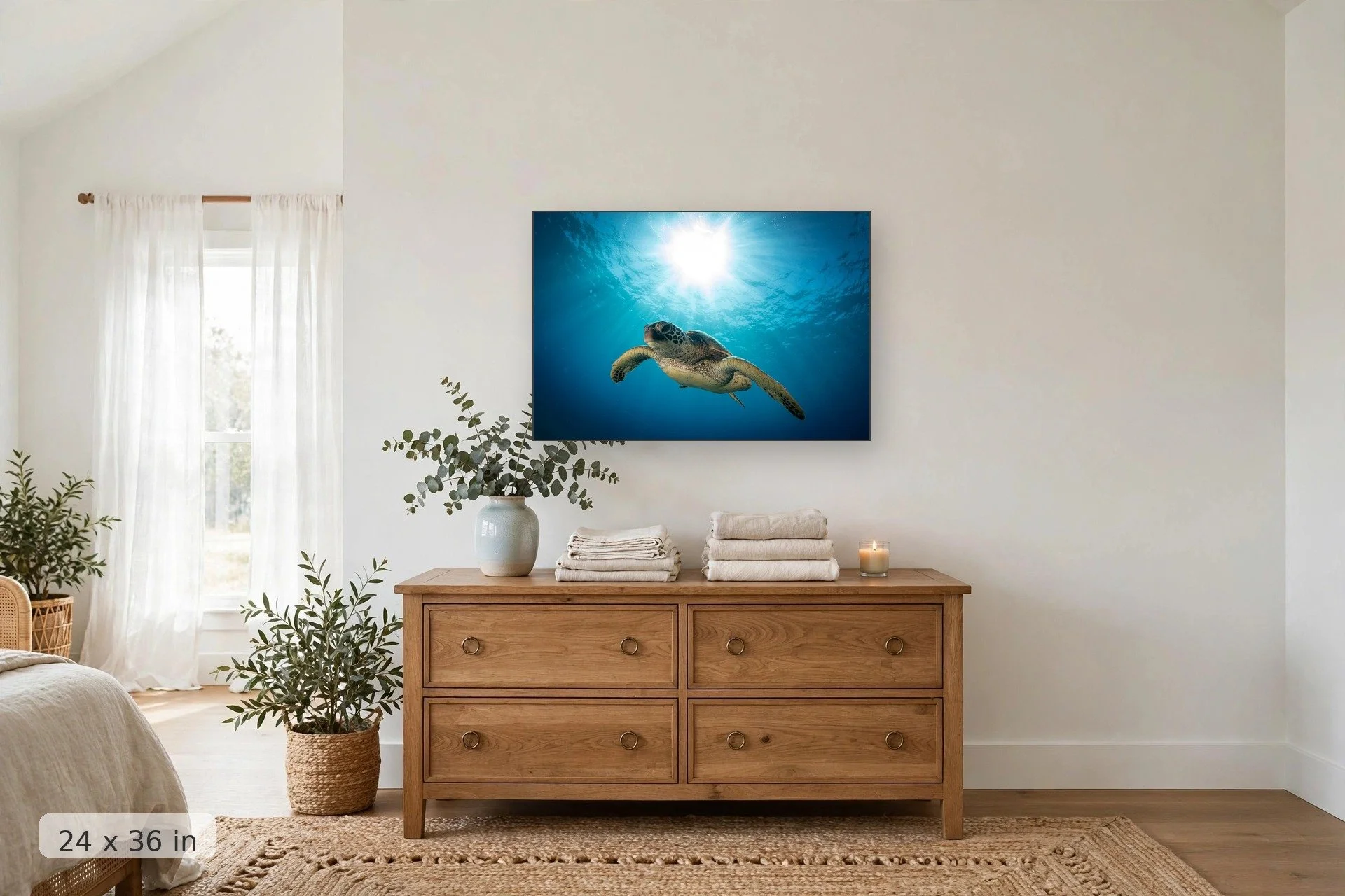 a turtle swims underwater with the sun forming a halo overhead — Honu Heaven print, 24x36 mockup above a dresser