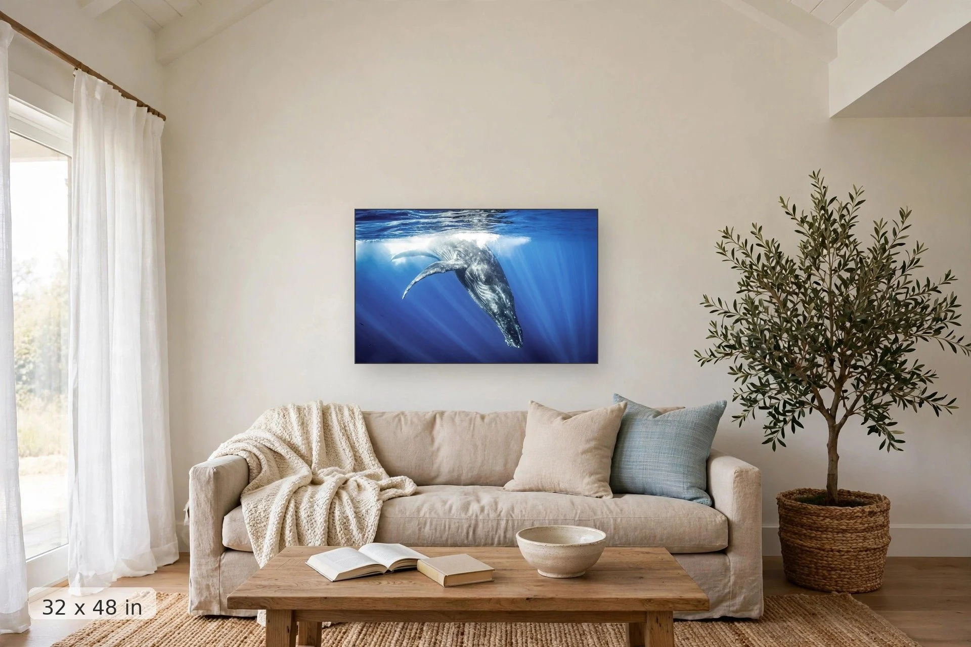 humpback whale diving below the ocean surface — Diving Whale print, 32x48 mockup above a living room sofa