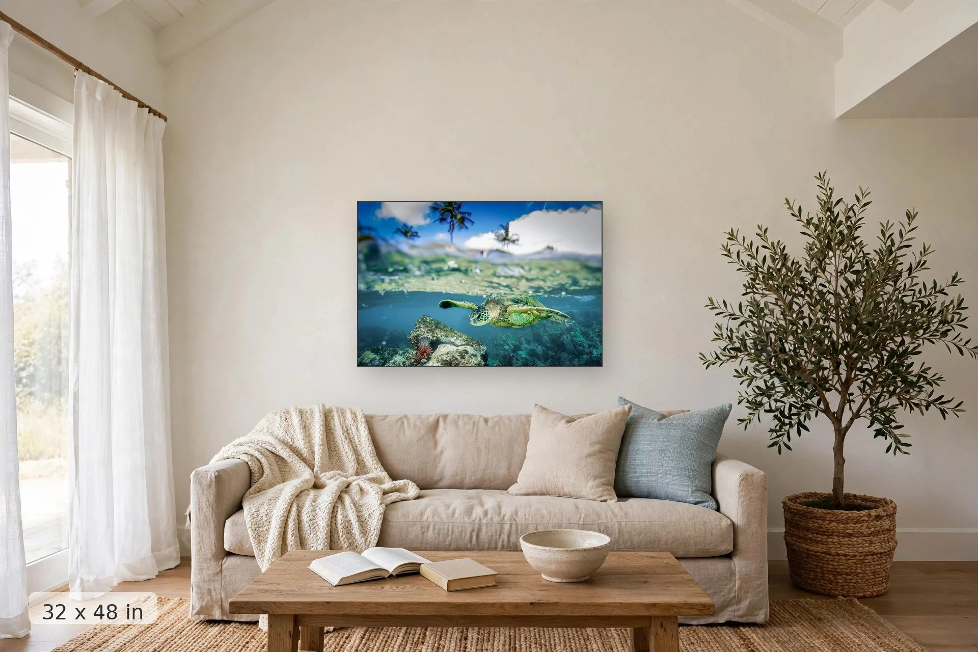 over under shot of turtle swimming over brightly colored coral — Honu Split print, 32x48 mockup above a living room sofa