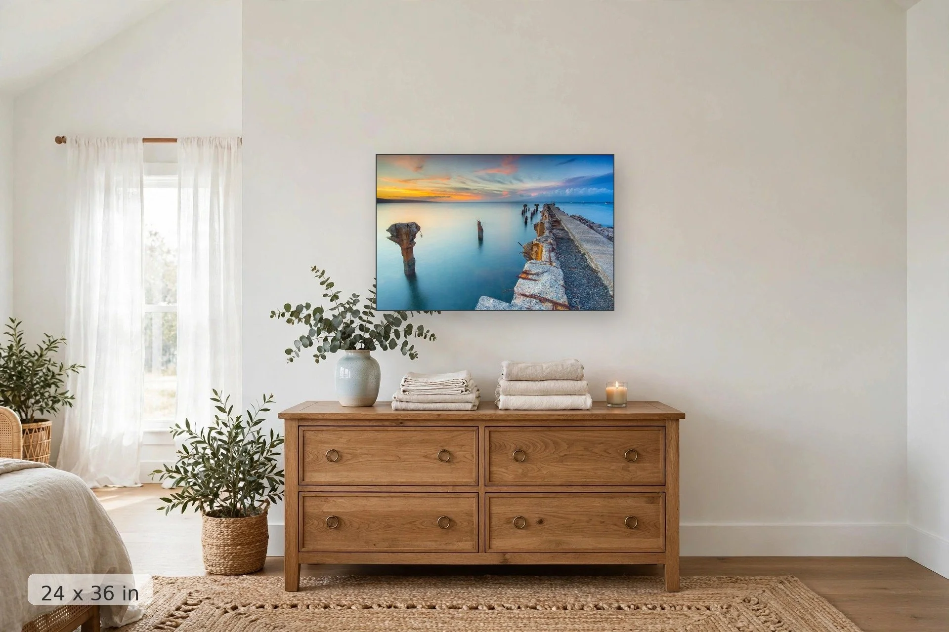 crumbling mala wharf looks out over serene blue water to orange sunset — Mala Remains print, 24x36 mockup above a dresser