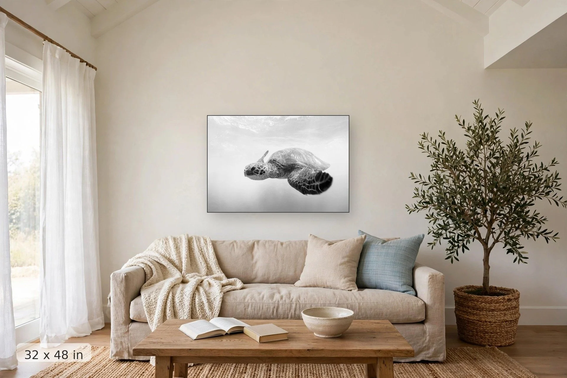 black and white turtle swimming — Makena Honu print, 32x48 mockup above a living room sofa