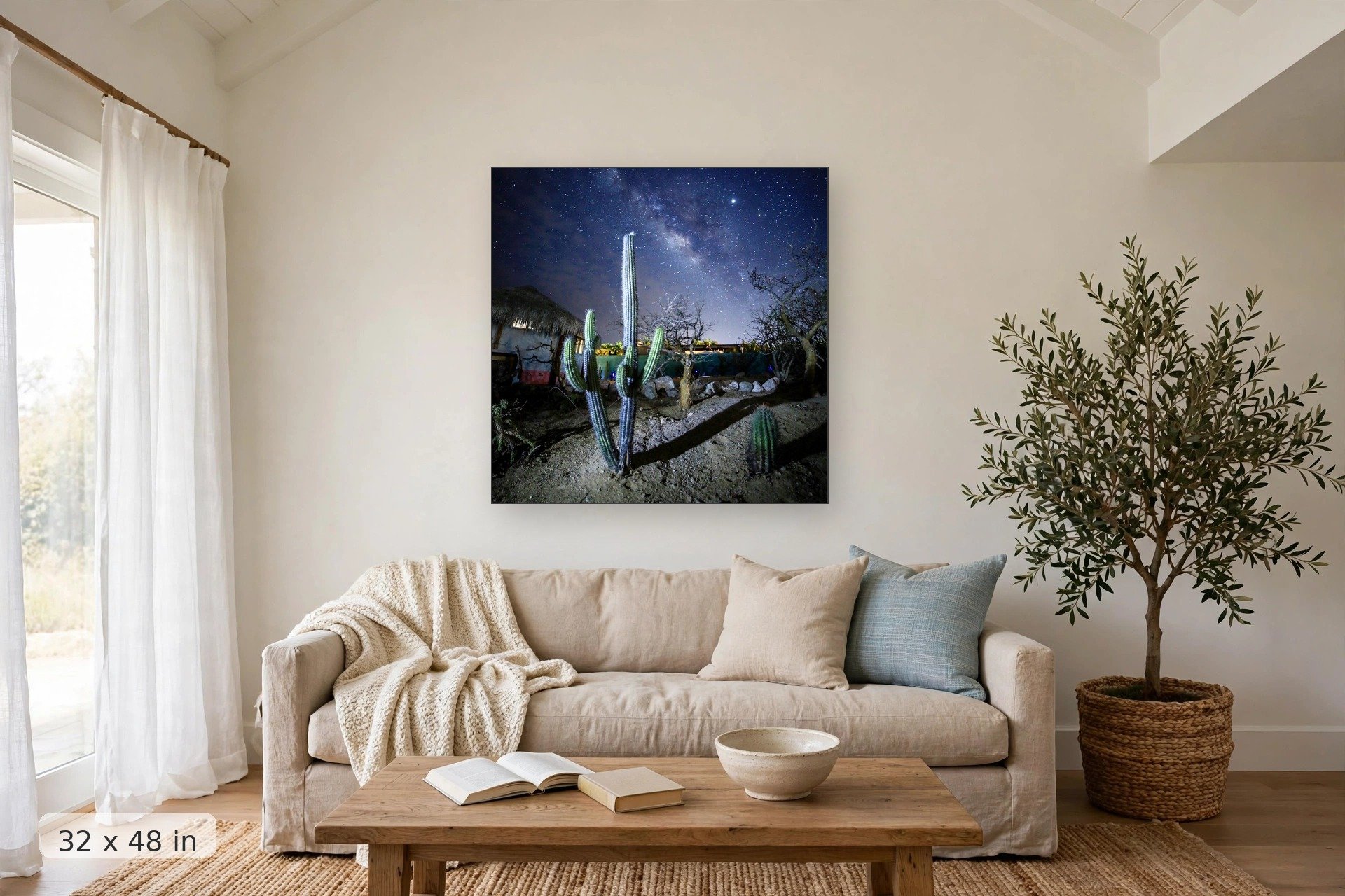 Milky Way galaxy over cactus — Palapas Galaxy print, 32x48 mockup above a living room sofa