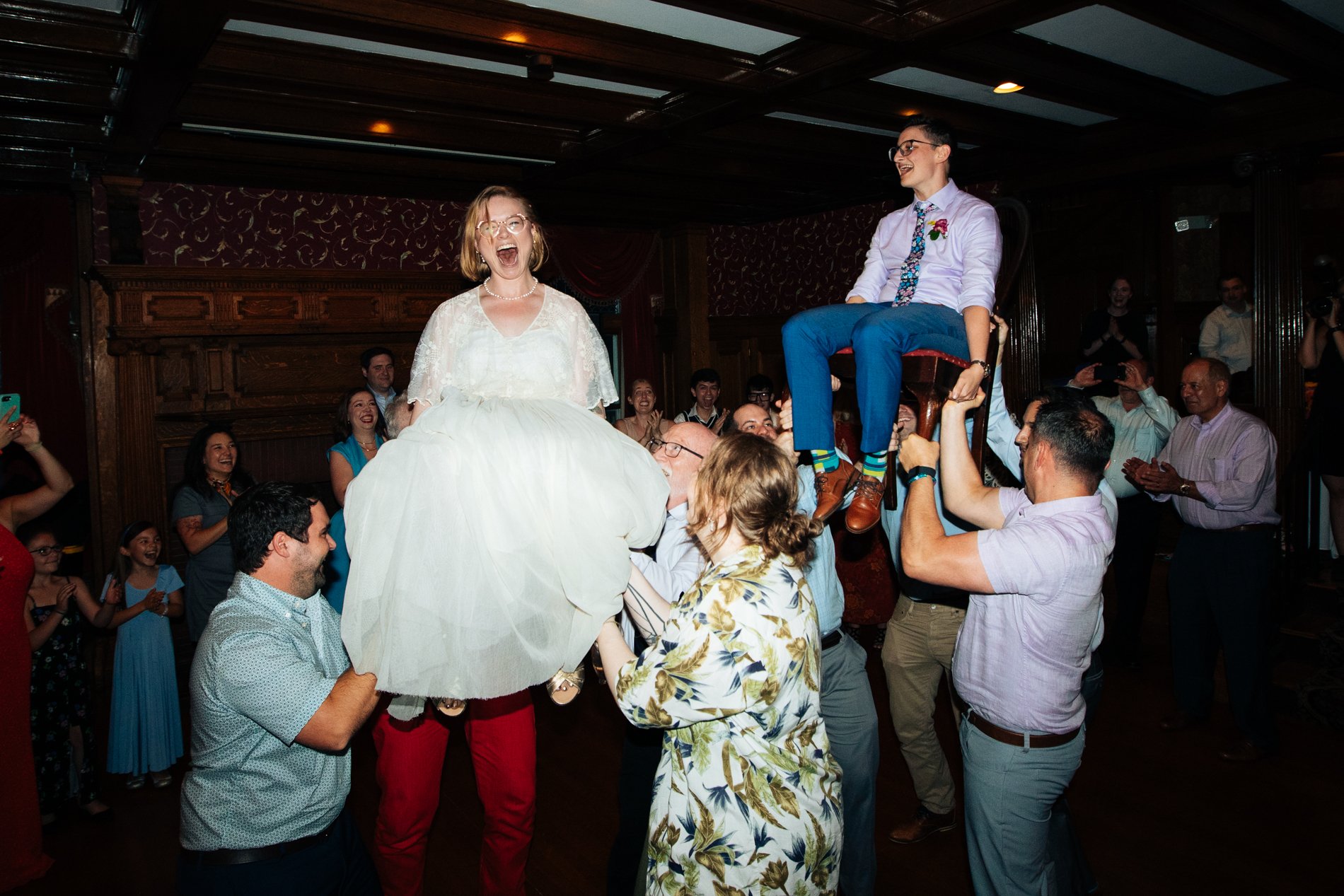  queer and nonbinary wedding couple dancing the hora at Endicott Estate in Massachusetts  