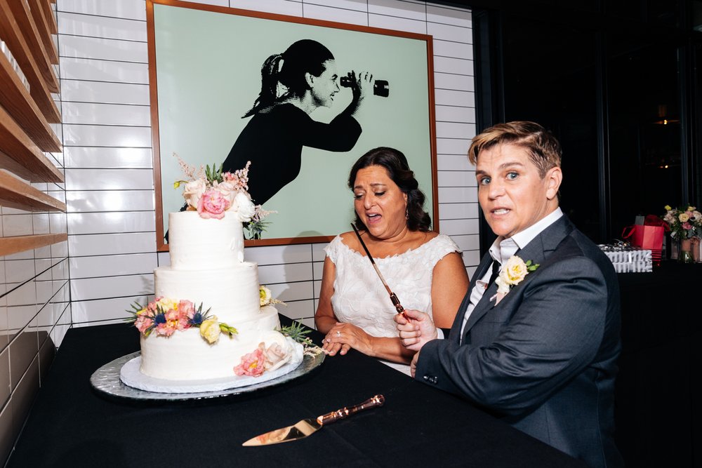 LGBTQ wedding couple cutting cake 