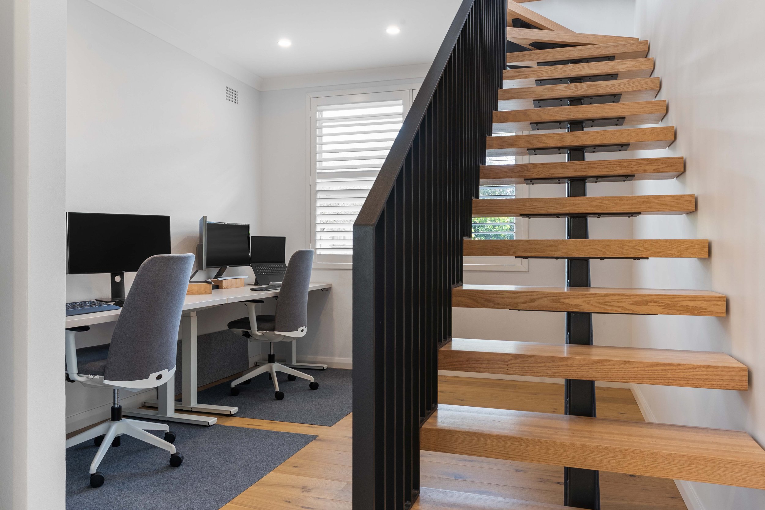A compact, versatile office space under the staircase.