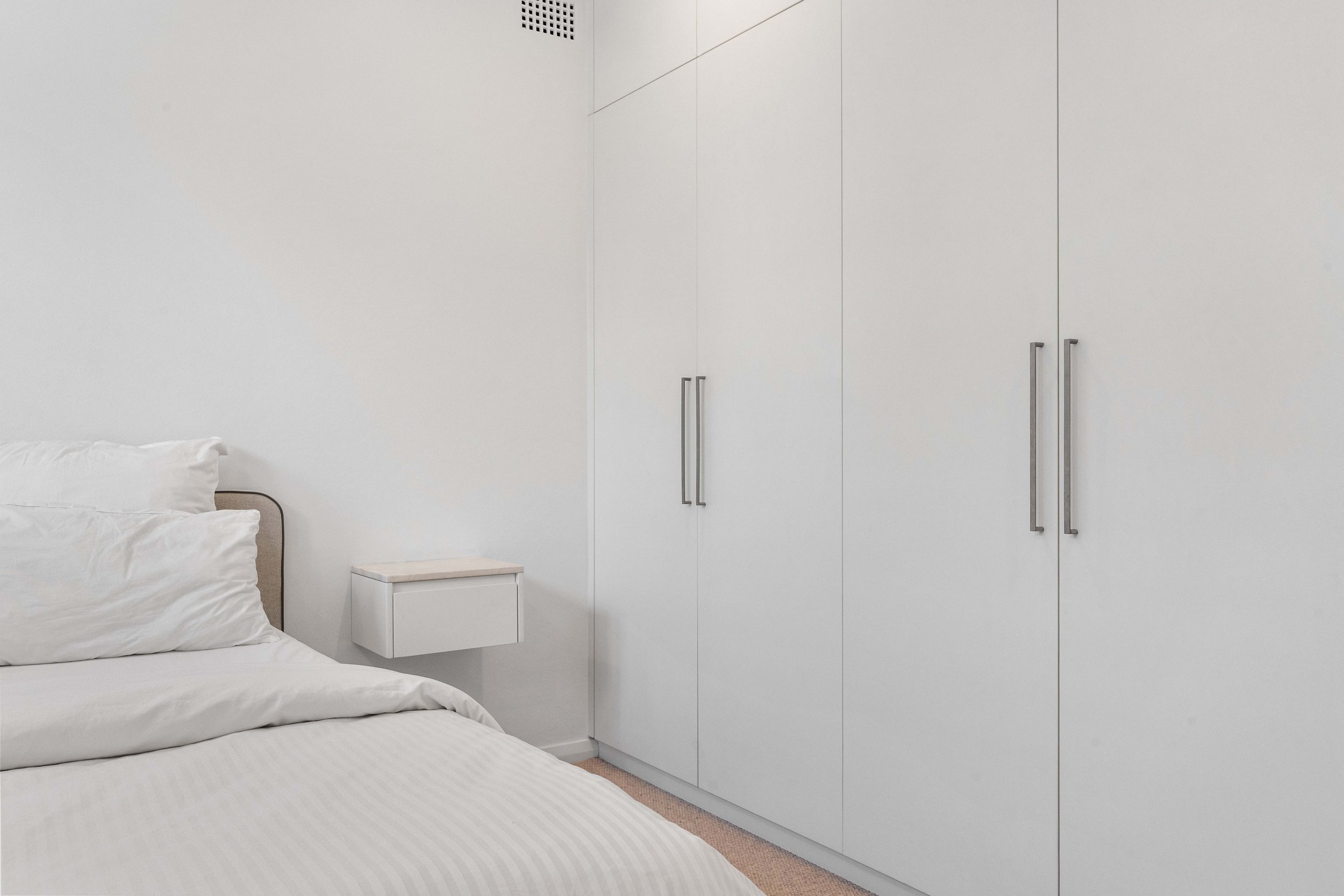 A calming, neutral, simple bedroom space.