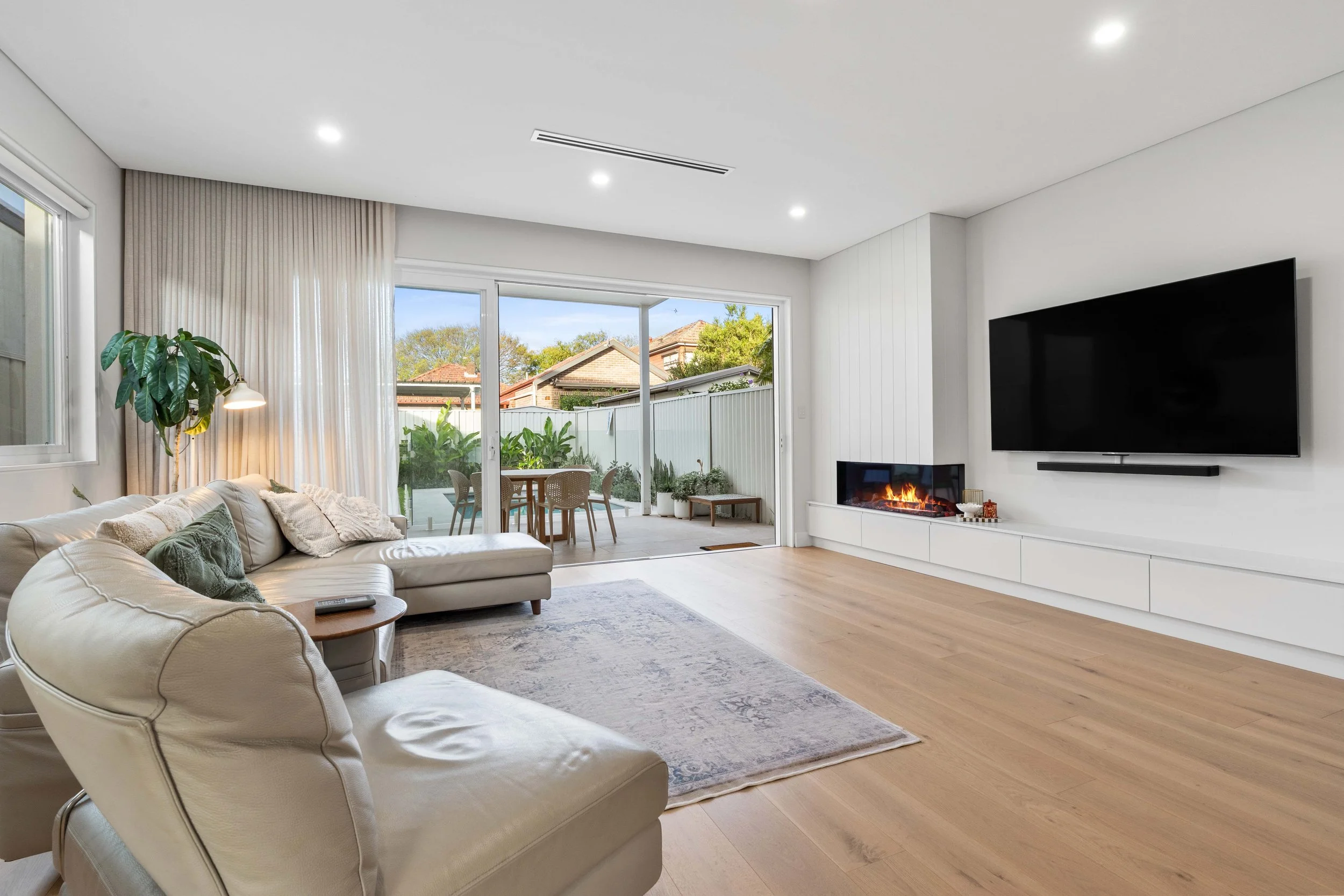 The transition from indoor to outdoor living is seamless in this home - the sheer curtains can be closed to create warmth and a hotel-like feel.