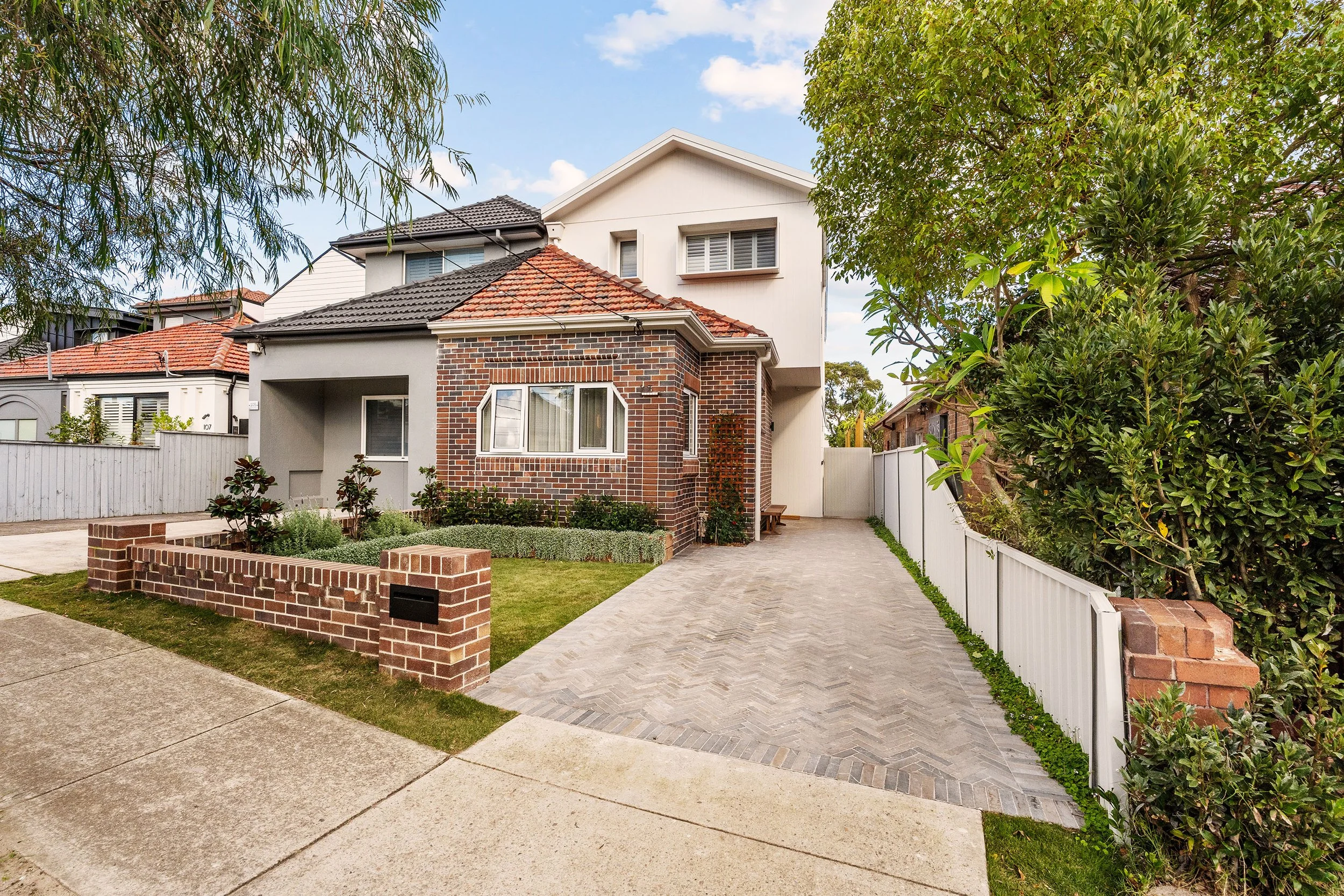 The original Art Deco brick façade was carefully restored, allowing the character of the 1930s home to remain at the heart of the transformation.