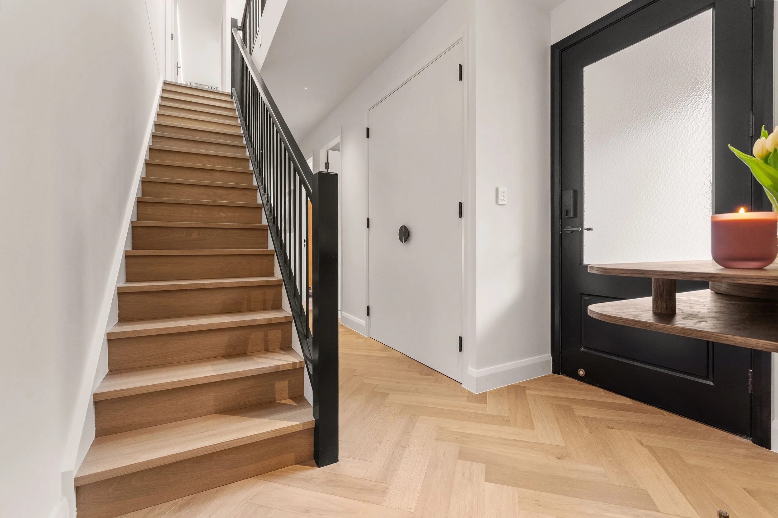 A refined transition between old and new, with herringbone timber flooring leading into the contemporary extension.