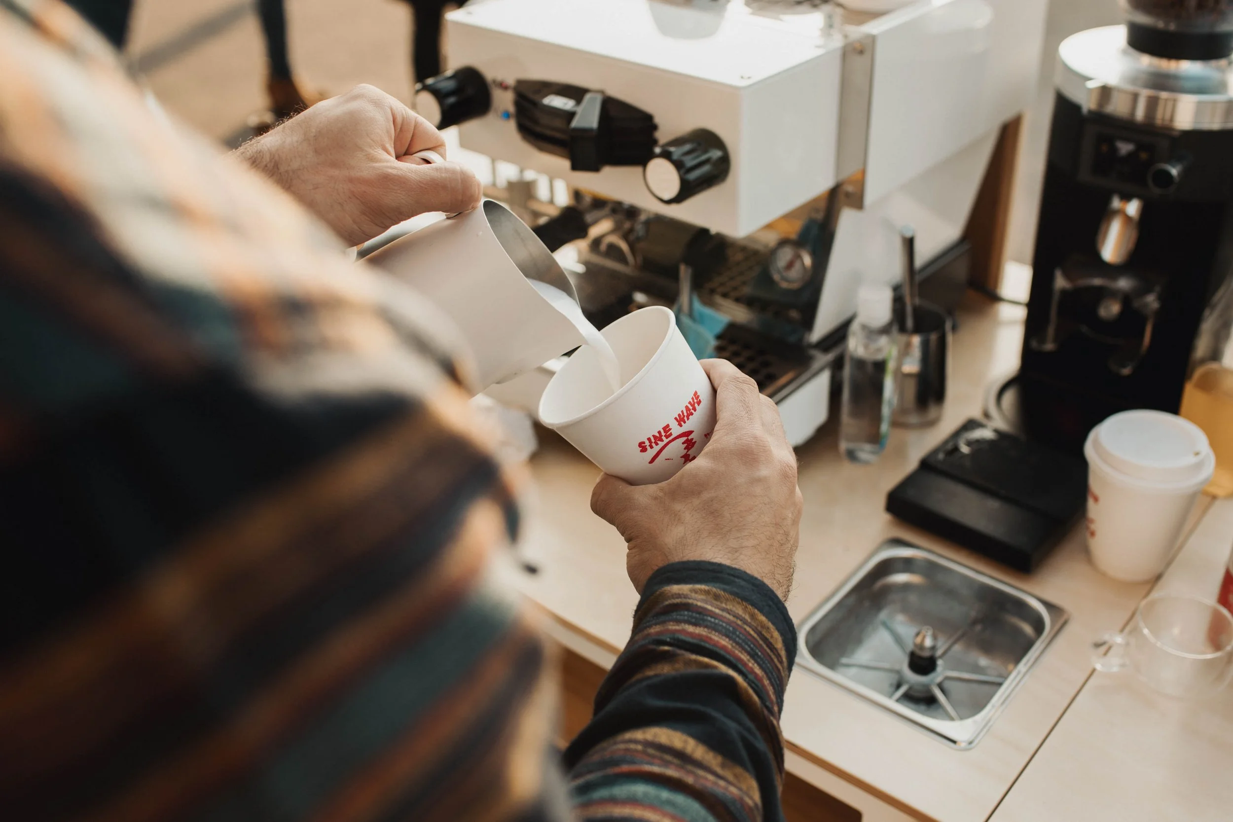 Latte art by Sine Wave Coffee mobile barista Jacksonville FL; Mobile coffee cart catering at Jacksonville wedding reception, private event, coffee catering, corporate event coffee; Sine Wave Coffee espresso cart setup at corporate event