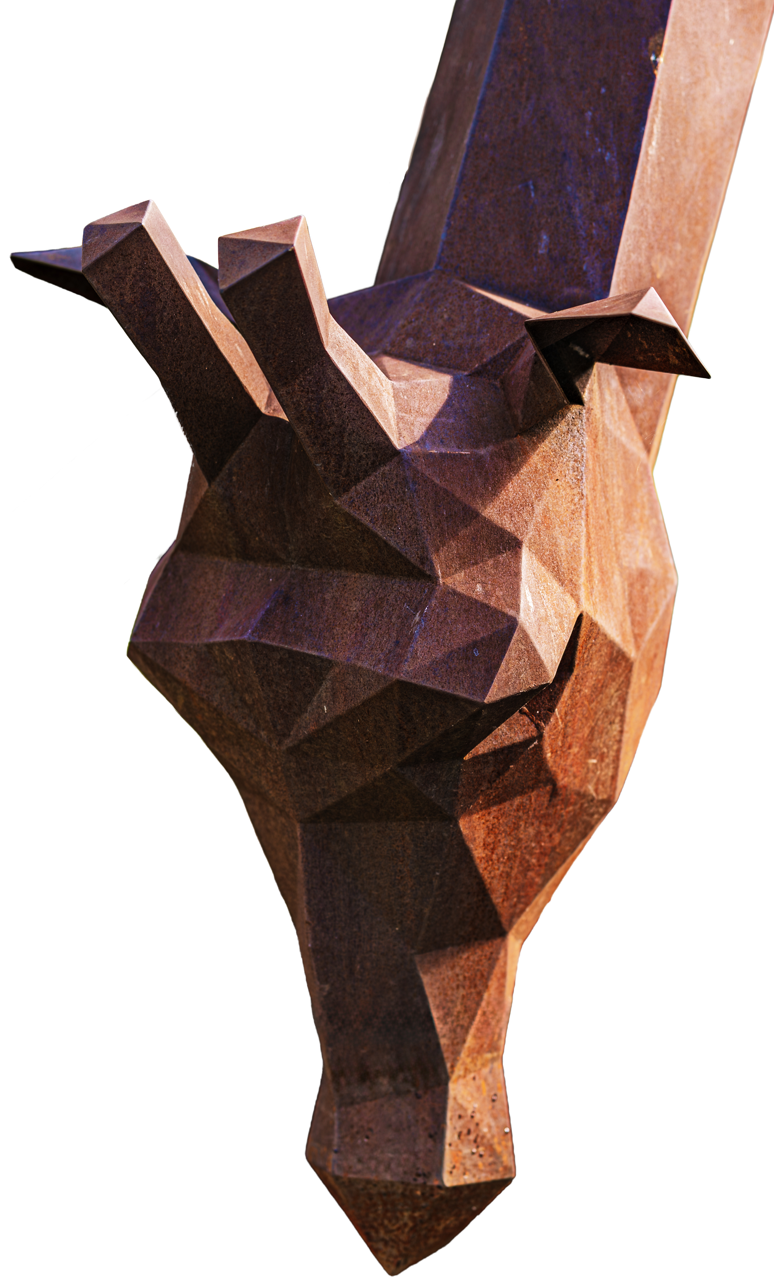 Close-up of a metal sculpture resembling a giraffe's head, with angular geometric features and pointed ears.