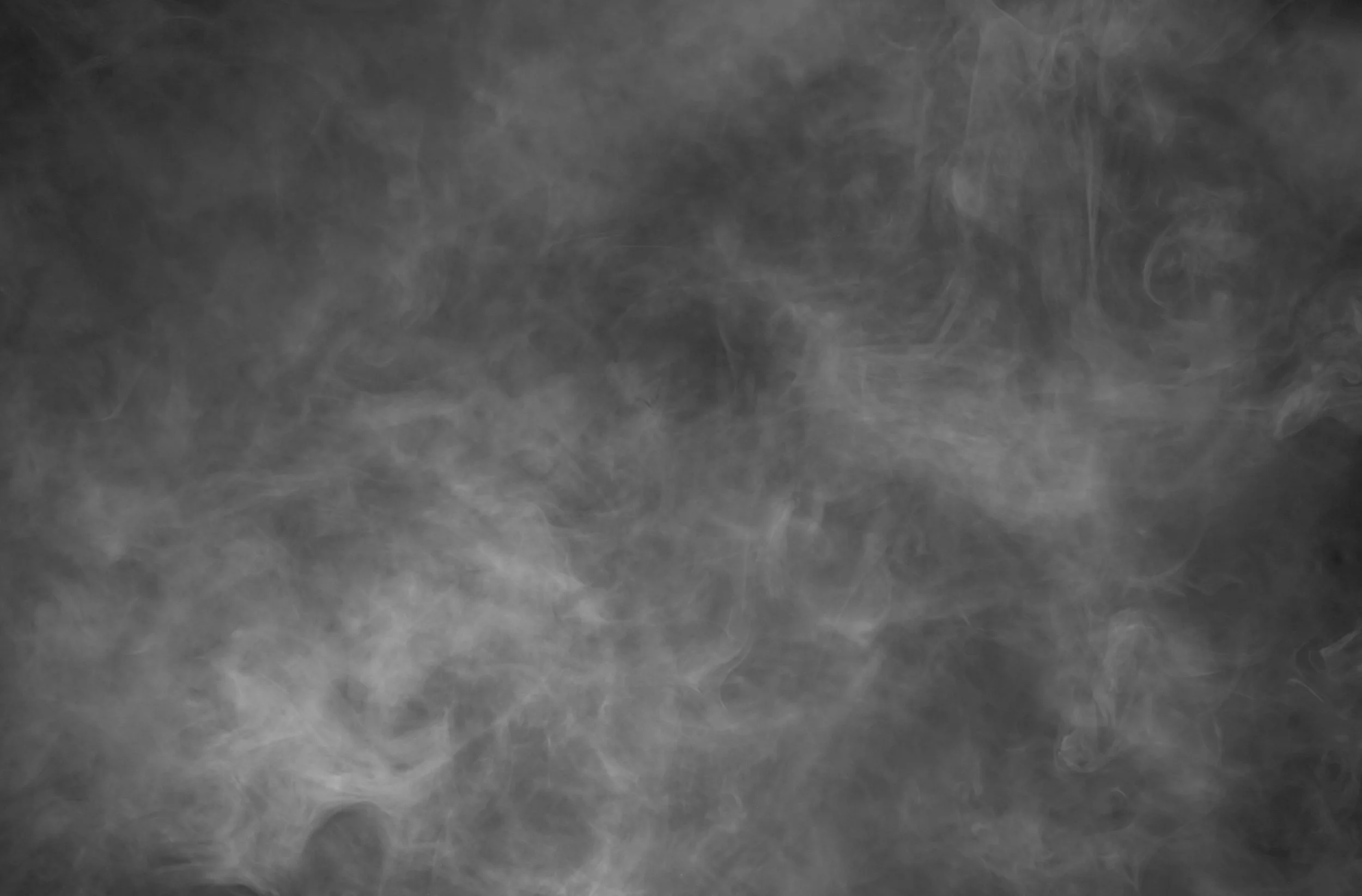 Gray textured background with swirling patterns resembling smoke on a dark gray surface.