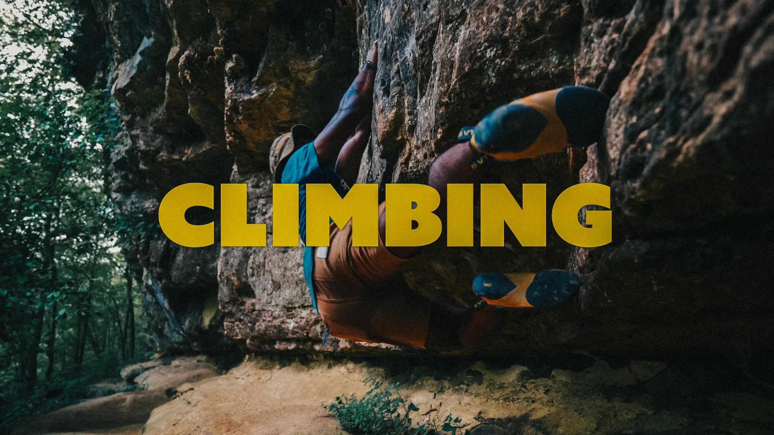 Person rock climbing on a large rock face outdoors surrounded by trees, with the word 'CLIMBING' in bold yellow letters over the image.